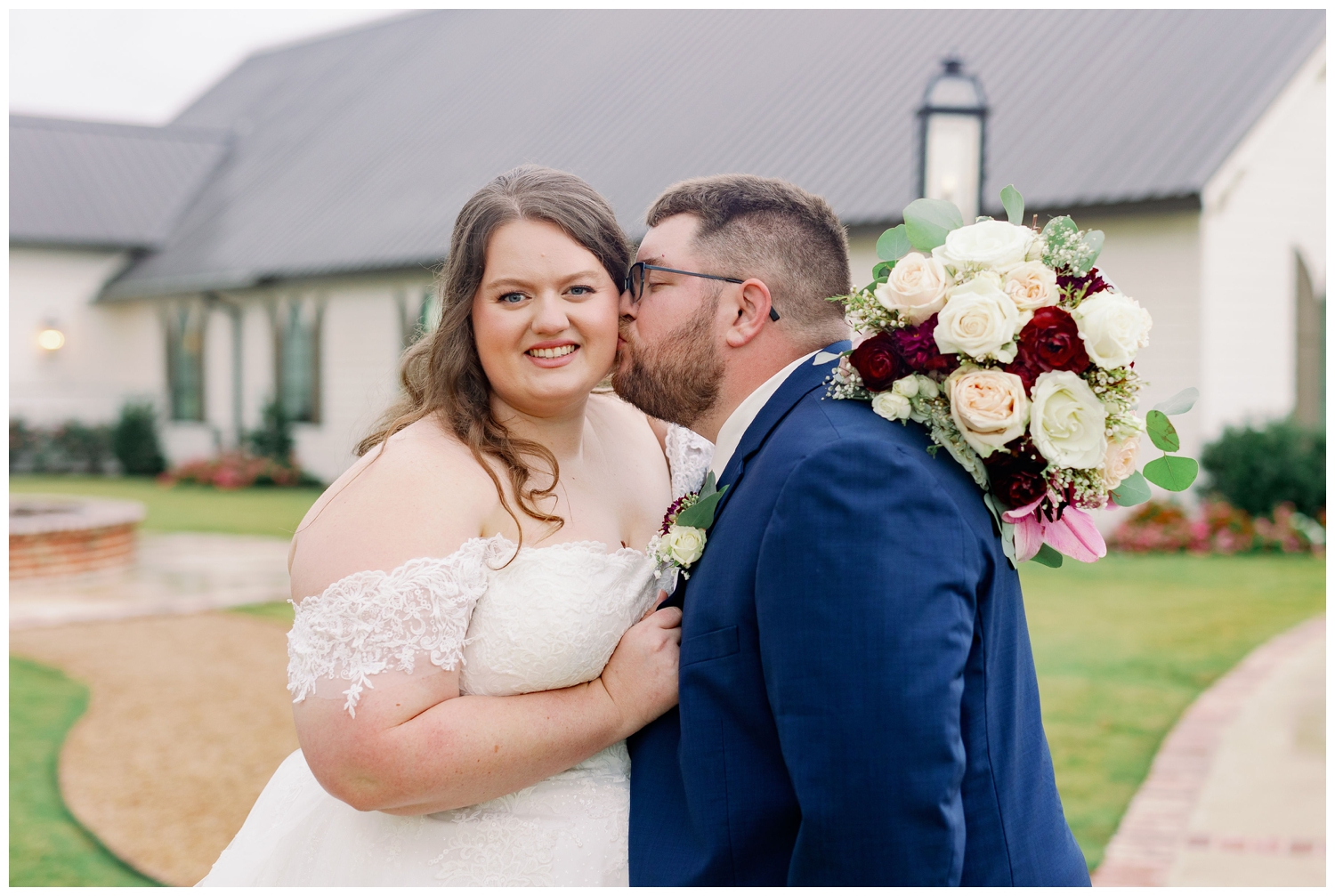 newlyweds kissing after wedding ceremony at Deep in the Heart Farms for College Station wedding photographer