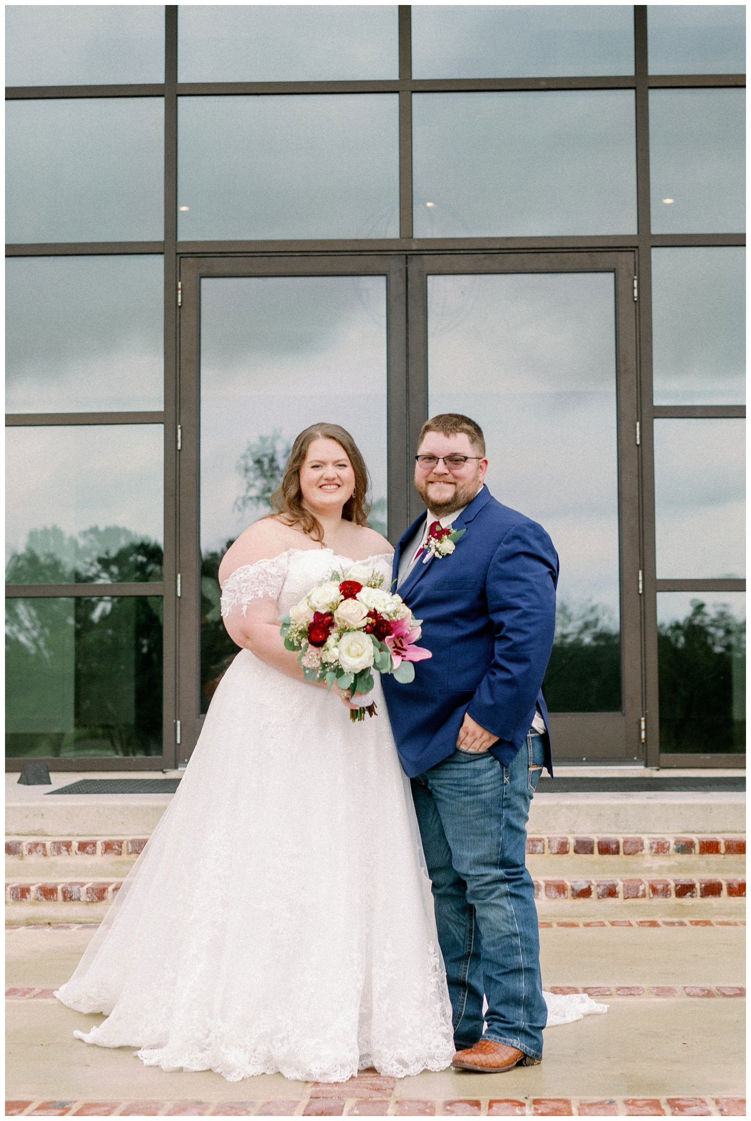 bride and groom posing and smiling fo College Station wedding photographer in front of Deep in the Heart Farms wedding venue
