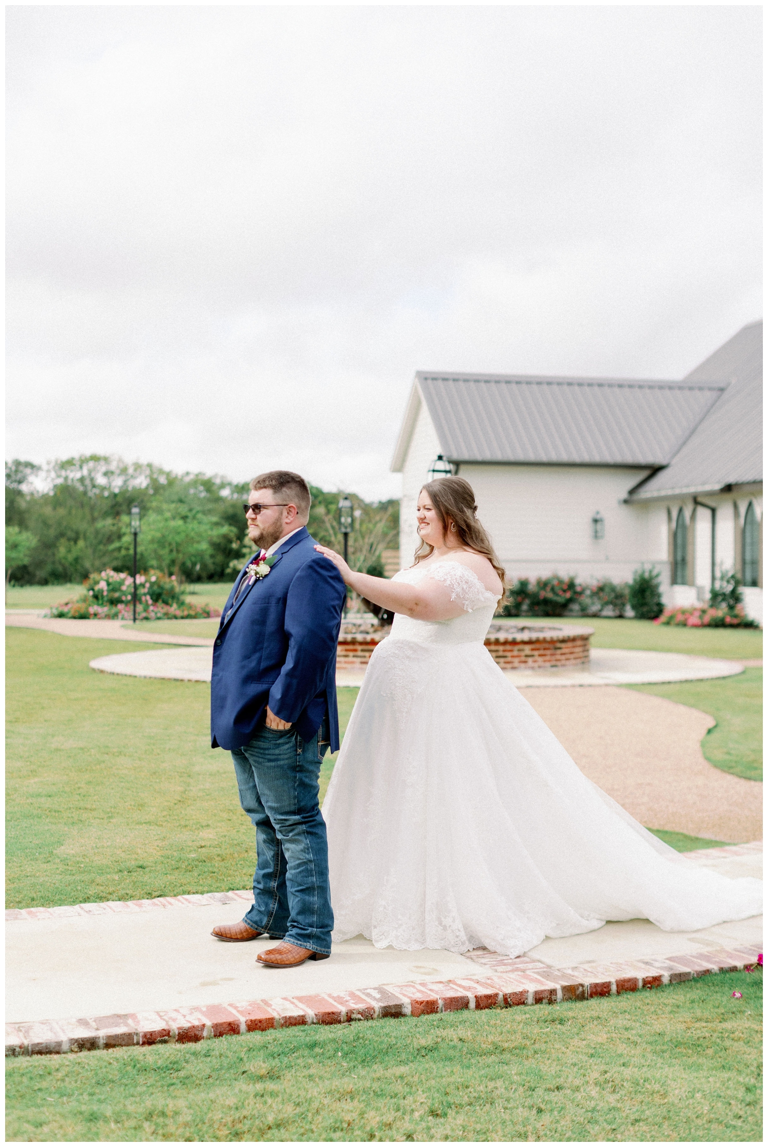 bride tapping grooms shoulder for College Station wedding photographer during a first look