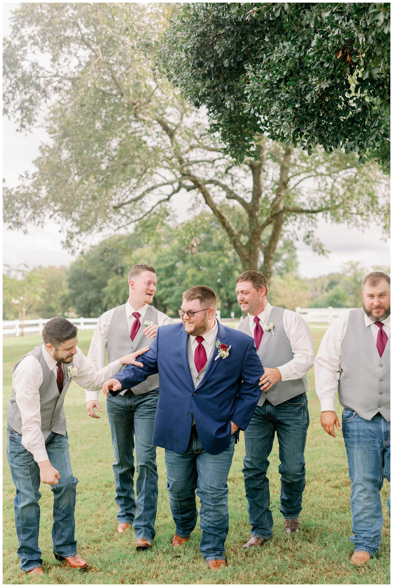 groom with groomsmen laughing on lawn at Navasota wedding venue