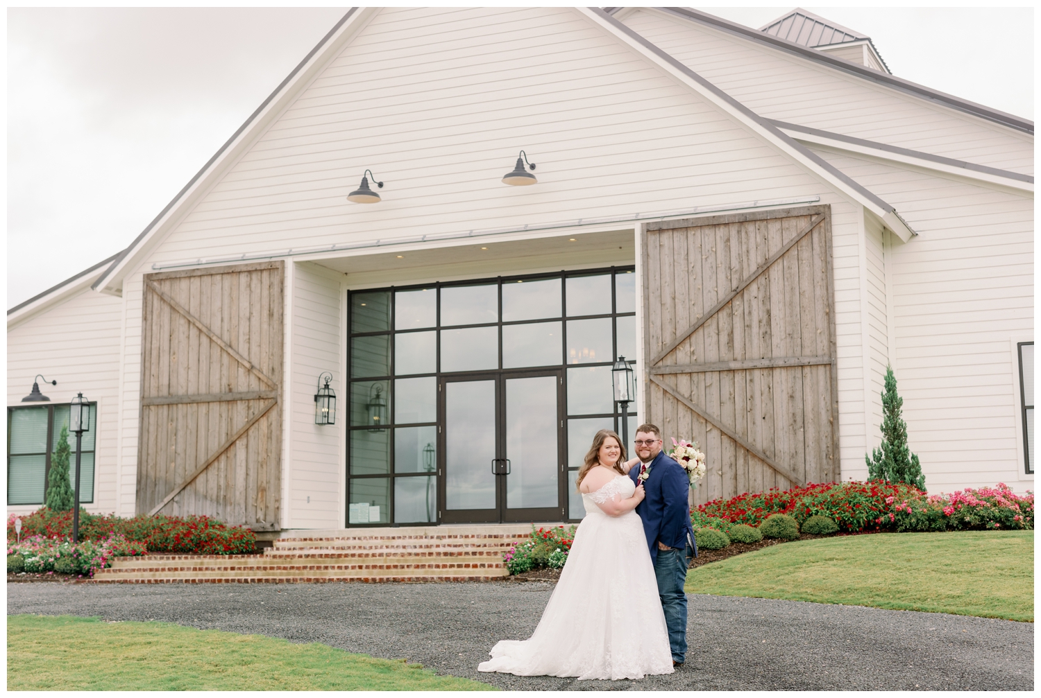 bride and groom standing in front of Deep in the Heart Farms posing for College Station wedding photographer