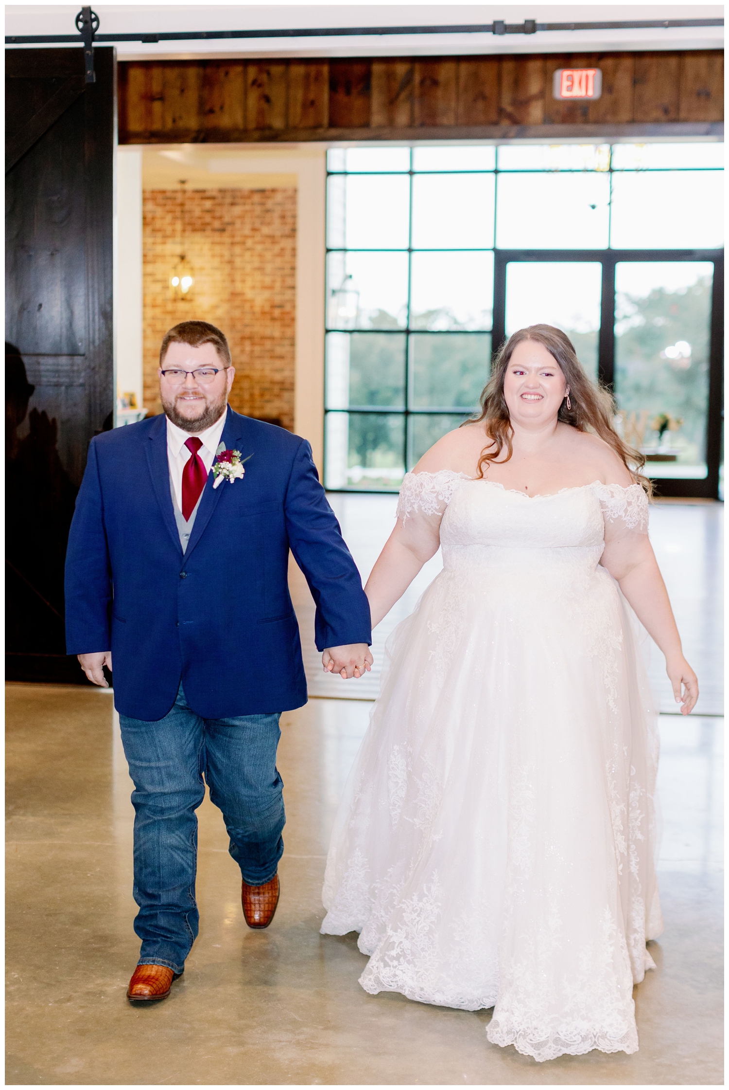 bride and groom entering wedding reception holding hands