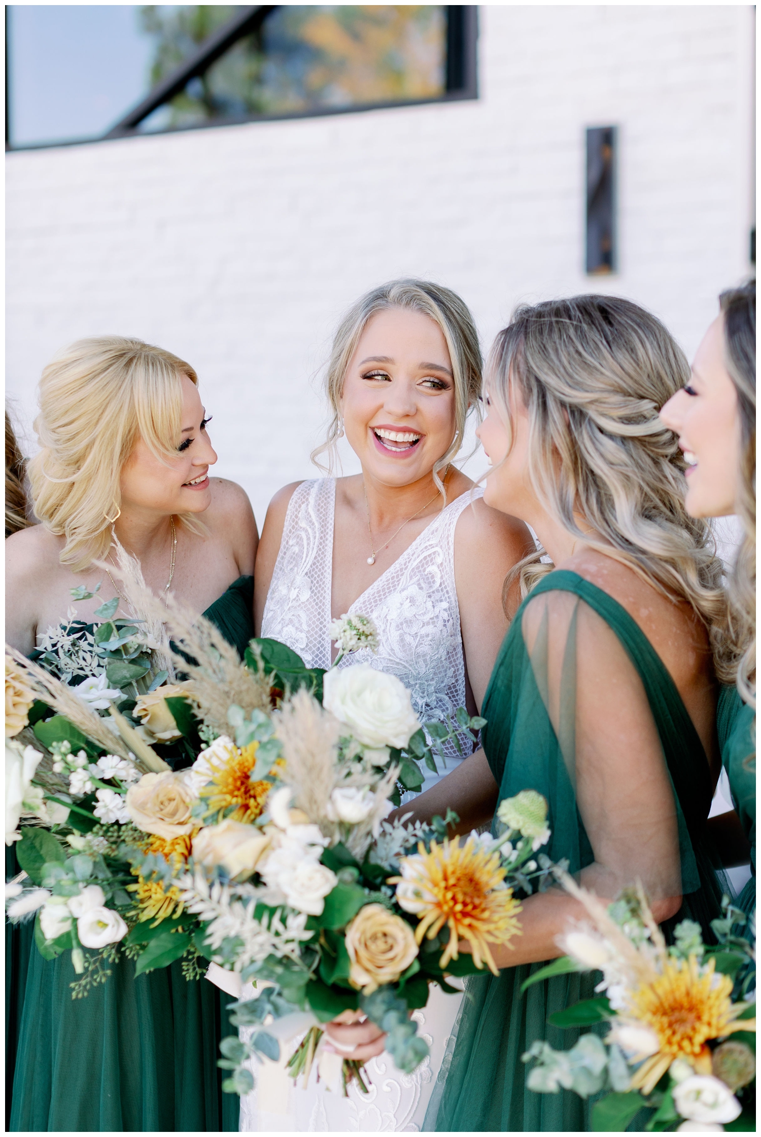 bride laughing with bridesmaids holding bouquets for Jennings Trace Wedding