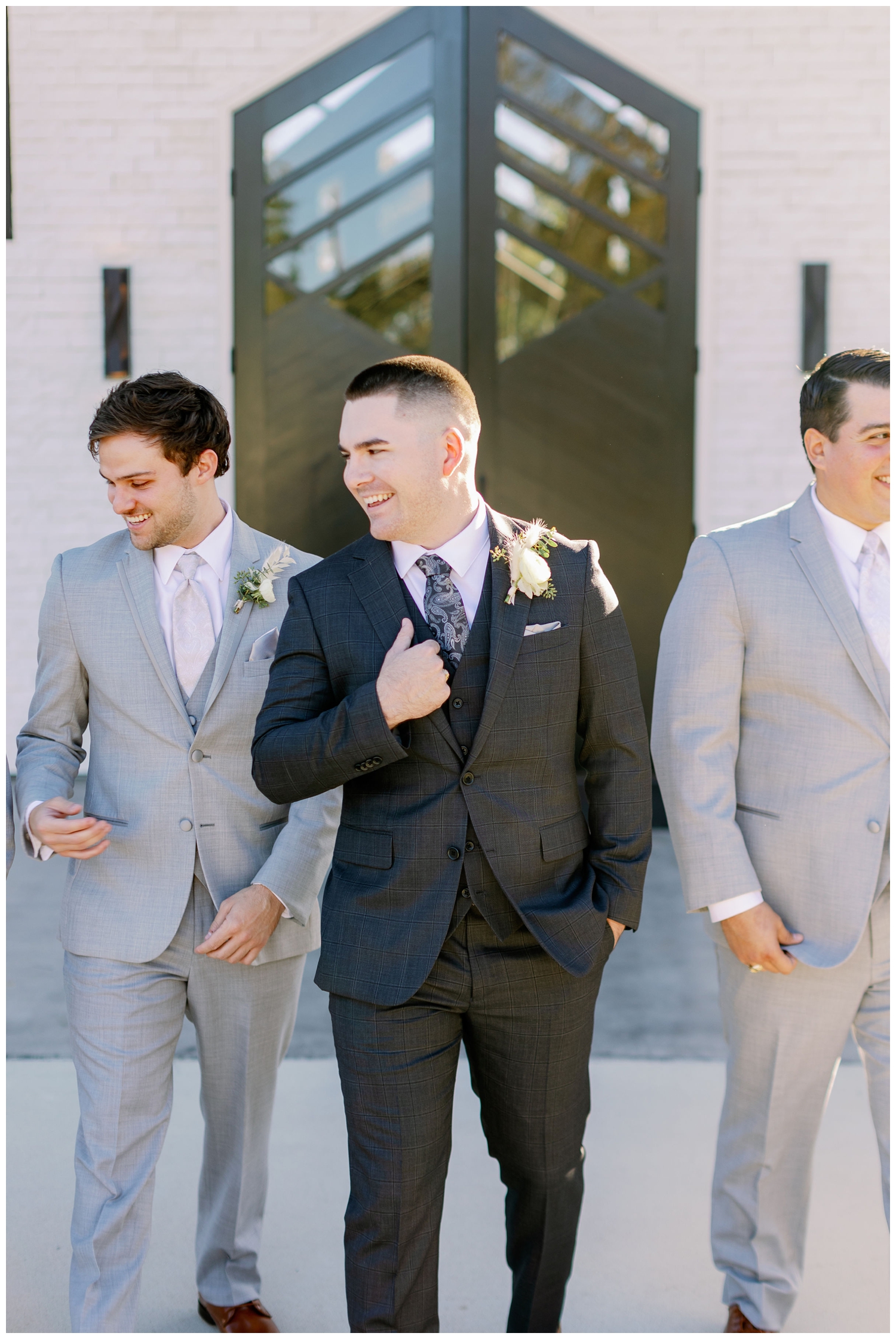 groom laughing with groomsmen
