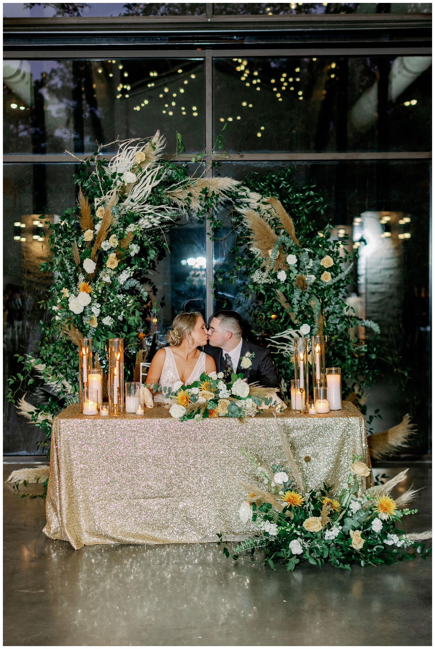 bride and groom kissing at sweetheart table Jennings Trace reception