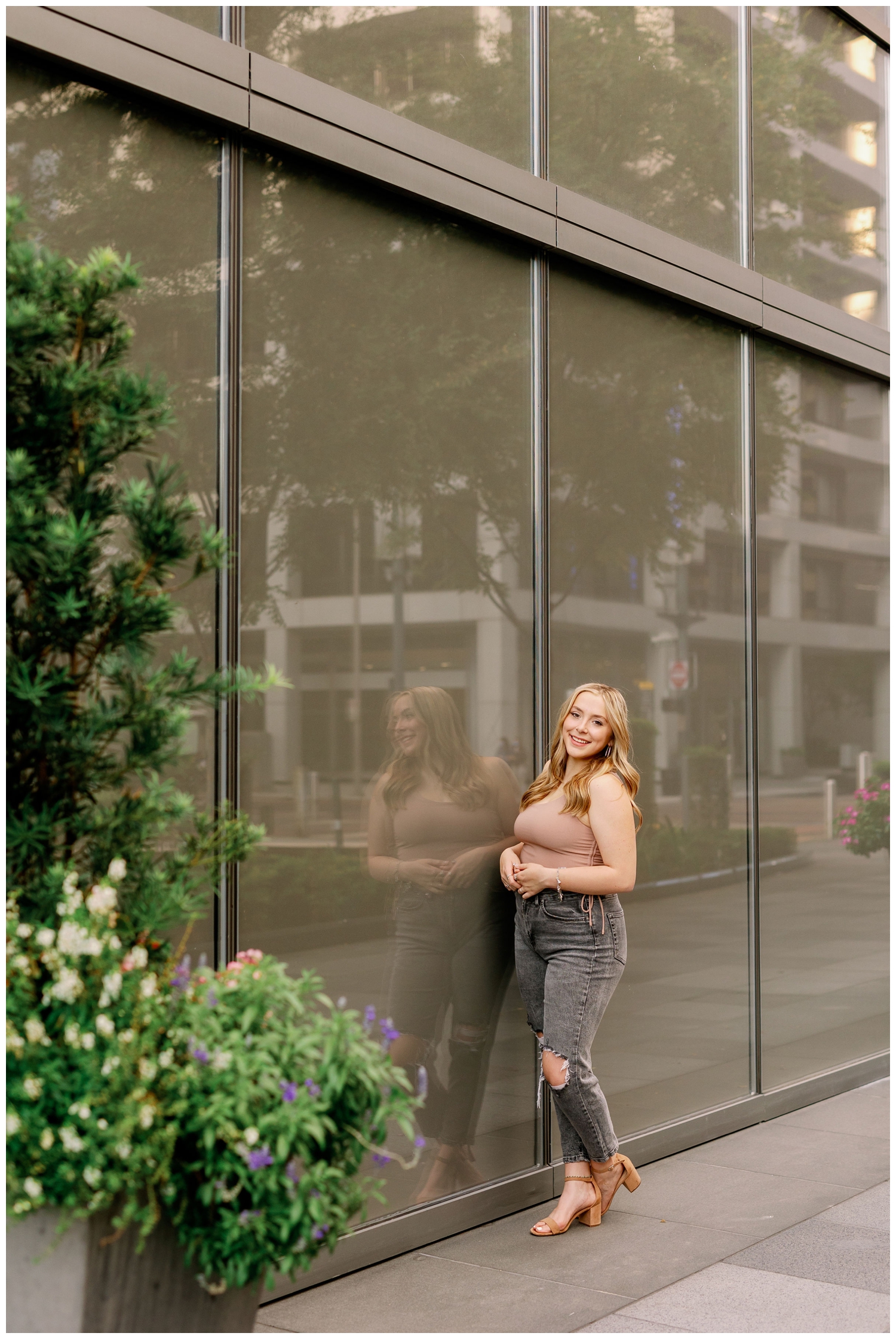 senior photos Main Street Houston with girl standing and leaning on a window
