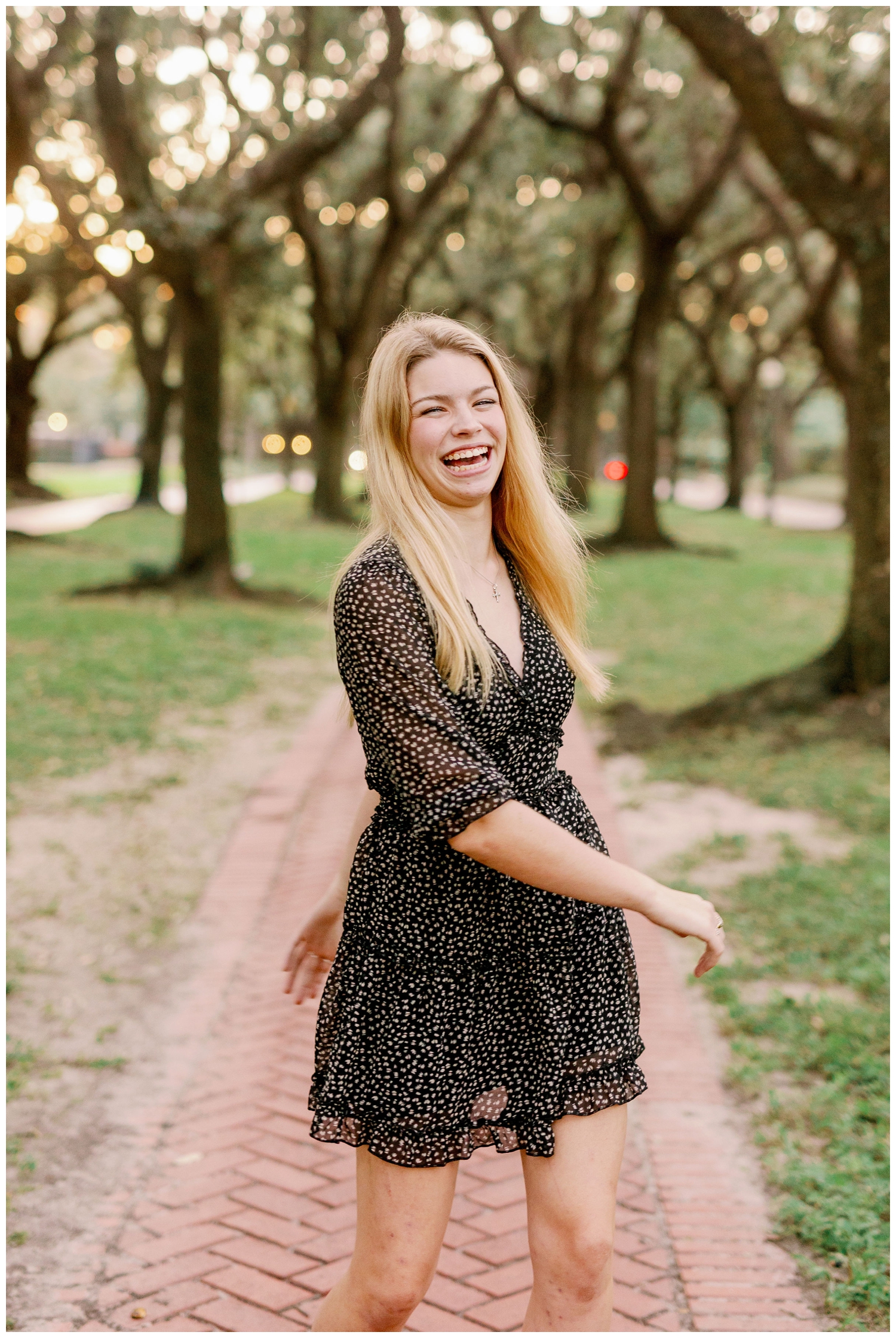 Senior Pictures South Boulevard with girl in black dress laughing and twirling