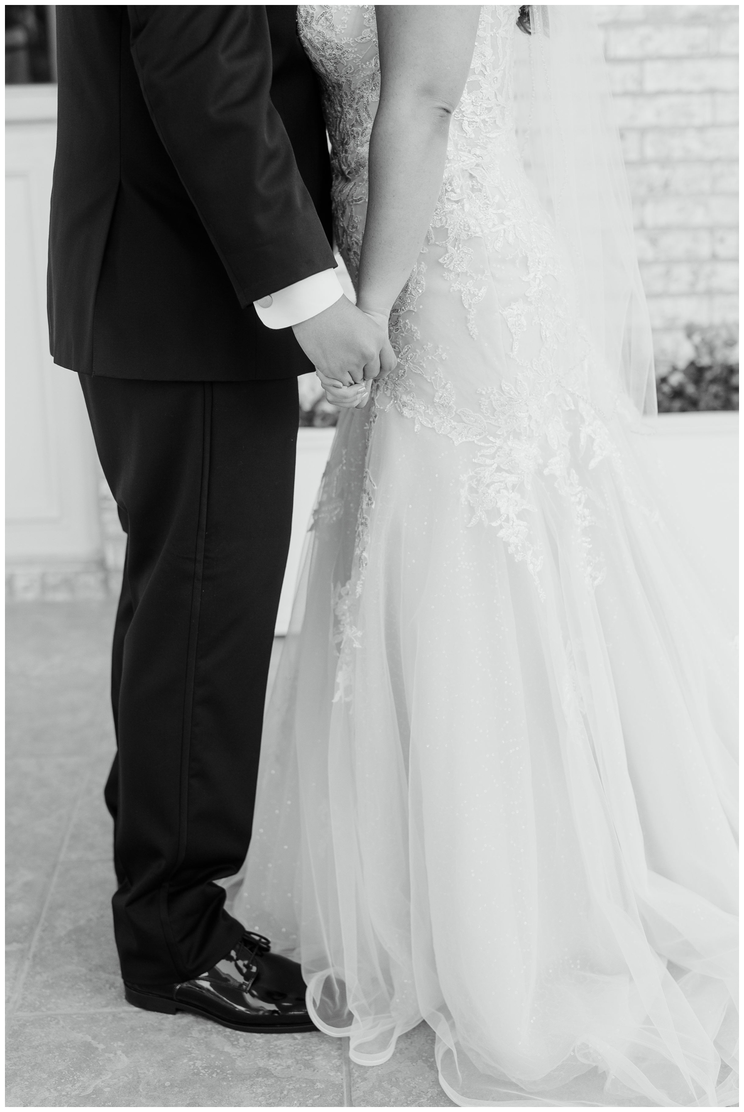 black and white portrait closeup of bride and groom holding hands at Sugar Creek Country Club wedding venue