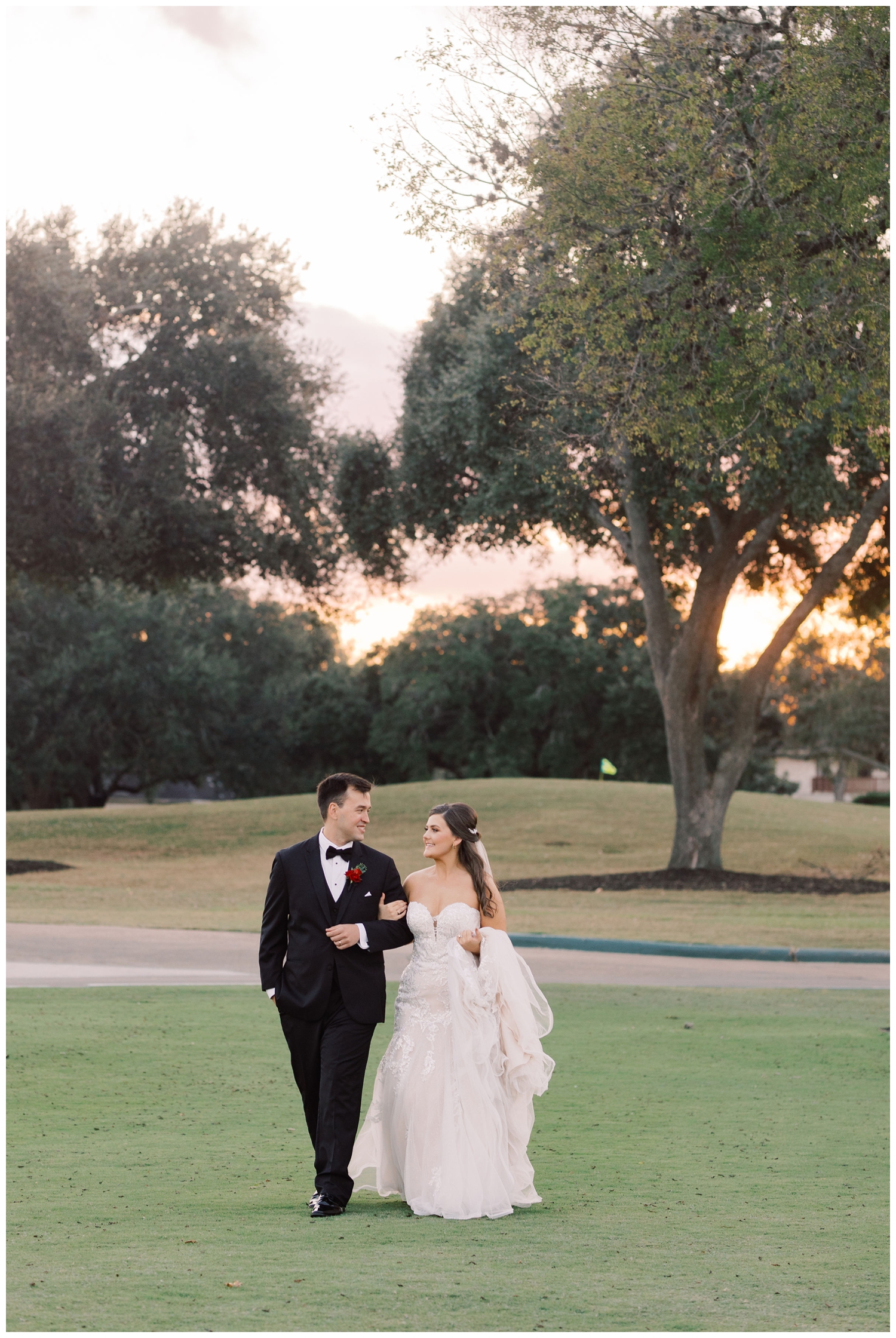 sunset portrait of bride and groom walking on the grounds outside Sugar Creek Country Club