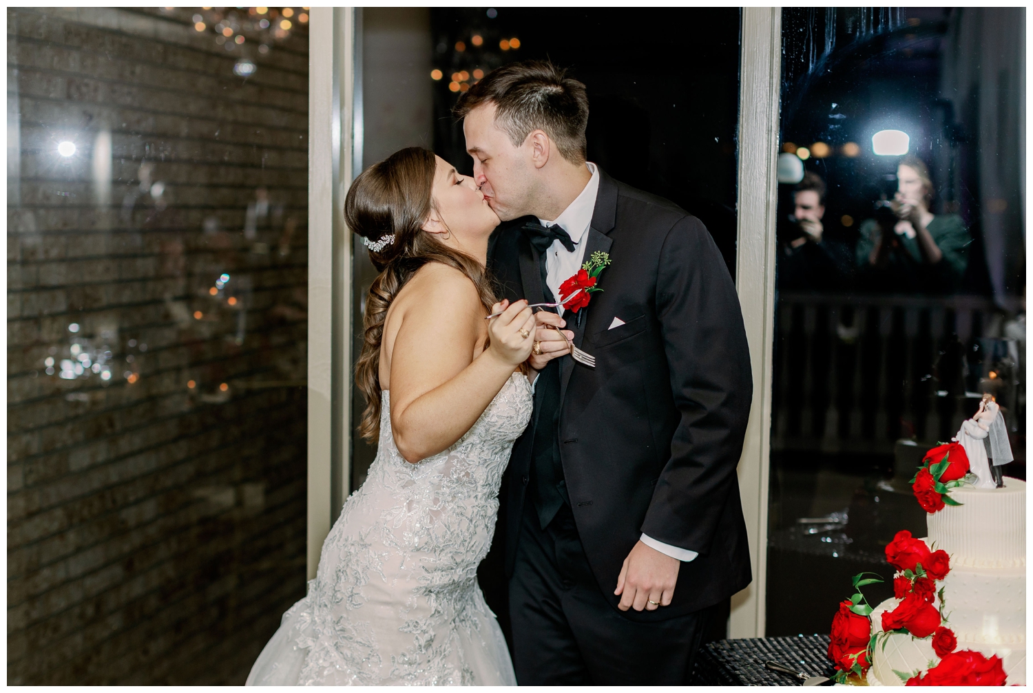 bride groom kissing after cake cutting inside Sugar Creek Country Club wedding reception