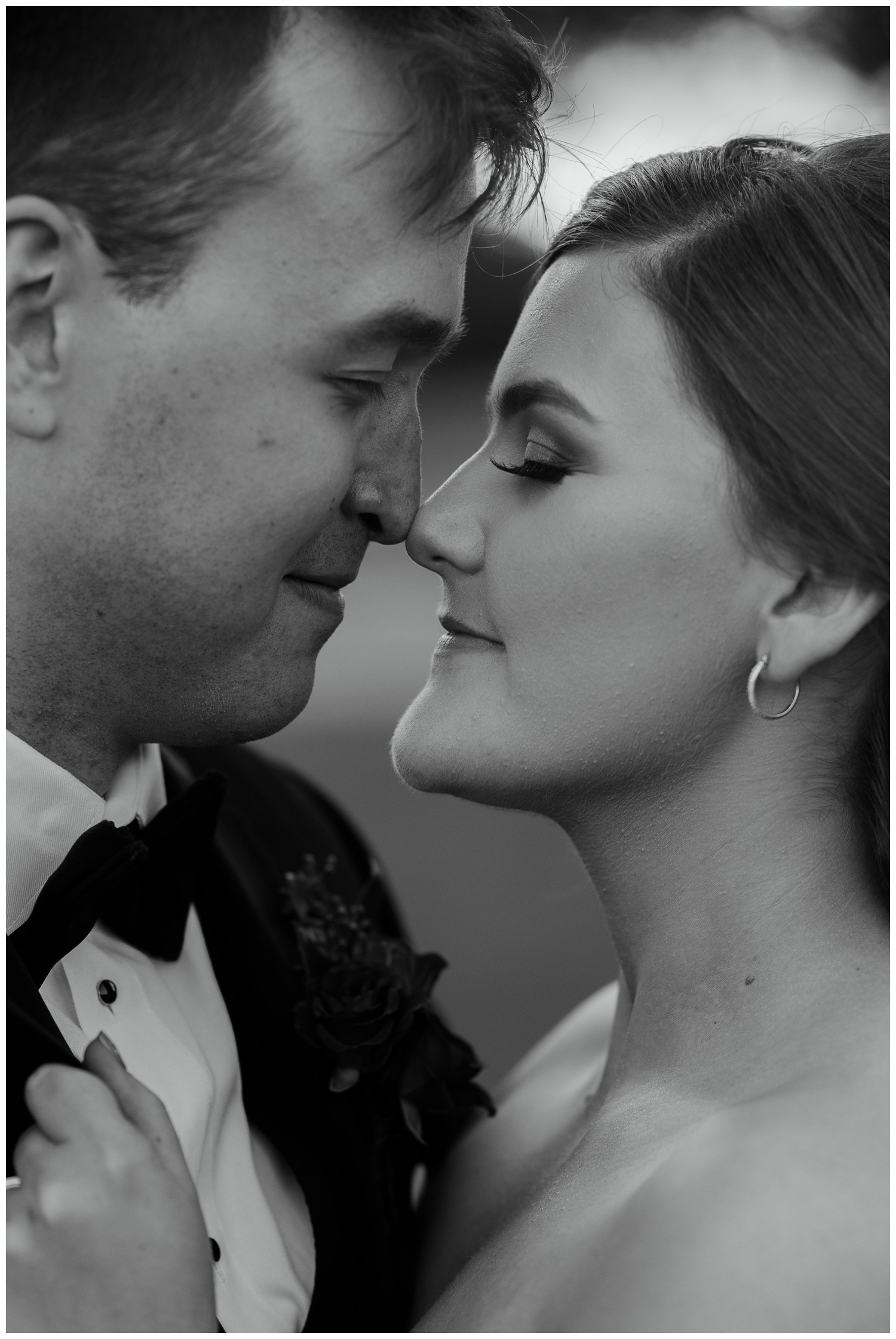 bride and groom nose to nose black and white portrait