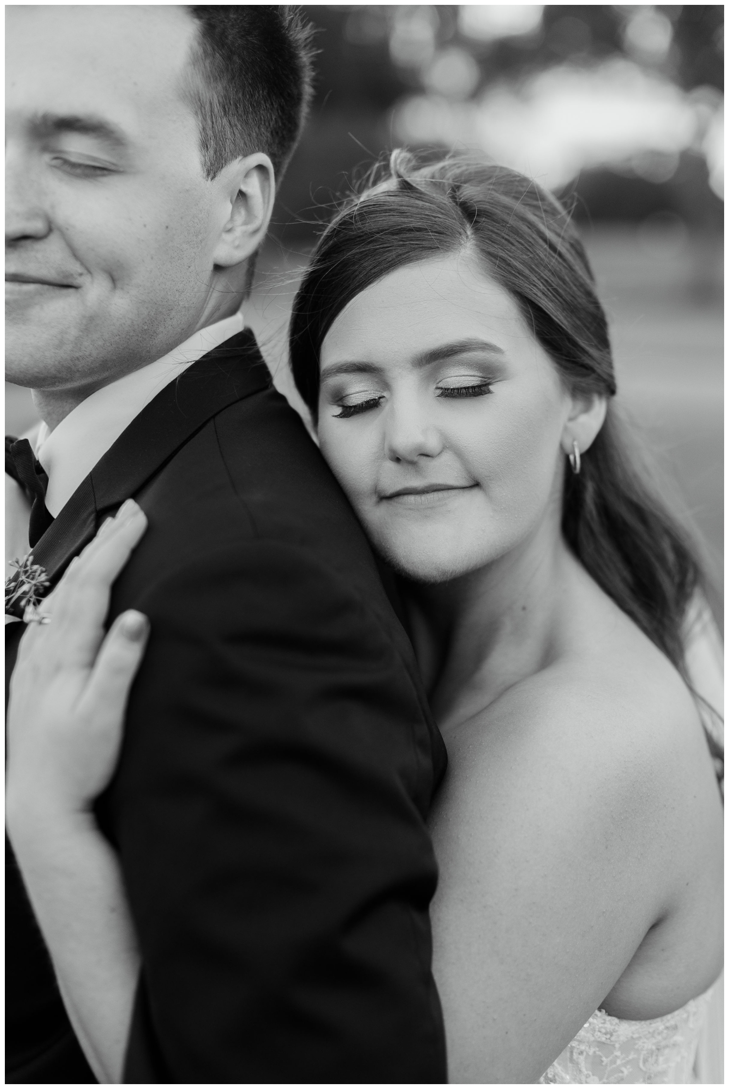 bride and groom embrace black and white portait