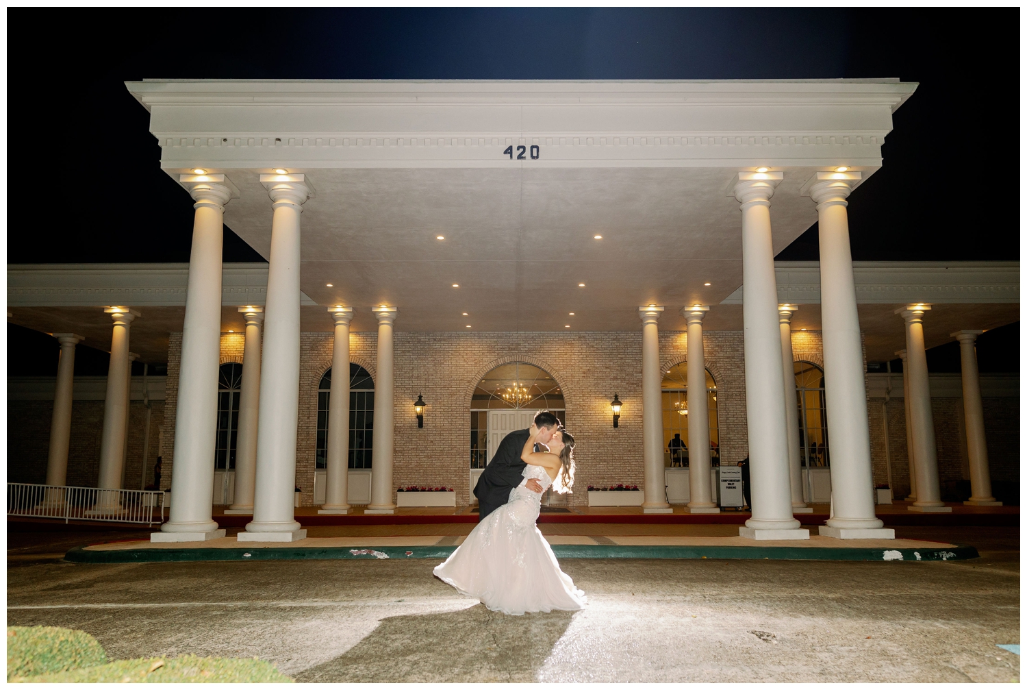 bride and groom night time portrait outside Sugar Creek Country Club