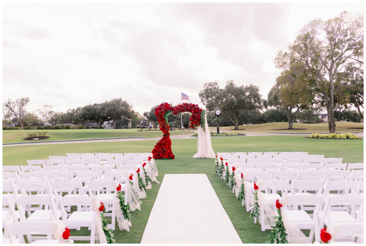 red floral arch ceremony space Sugar Creek Country Club wedding