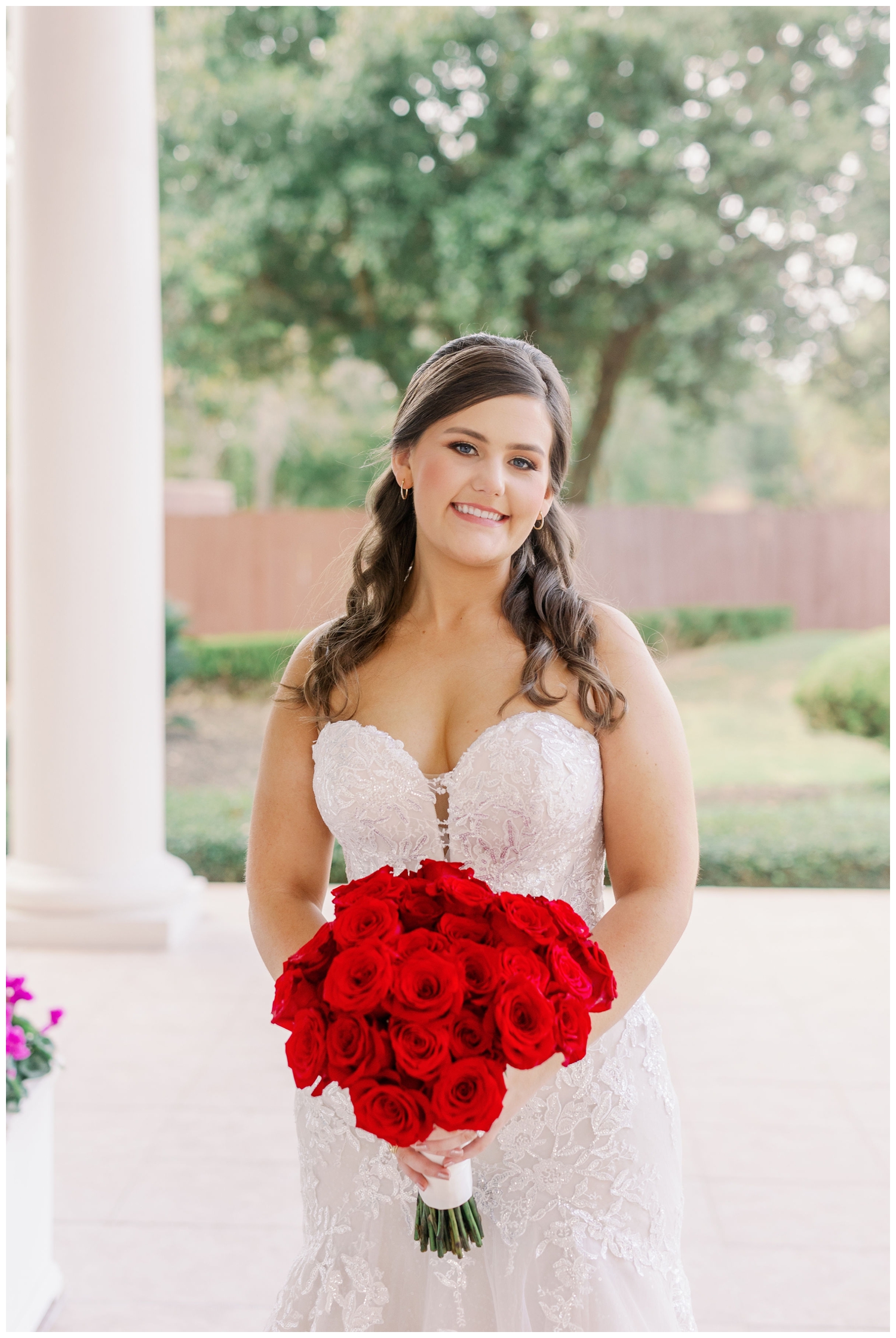 closeup portrait of bride with red rose bouquet