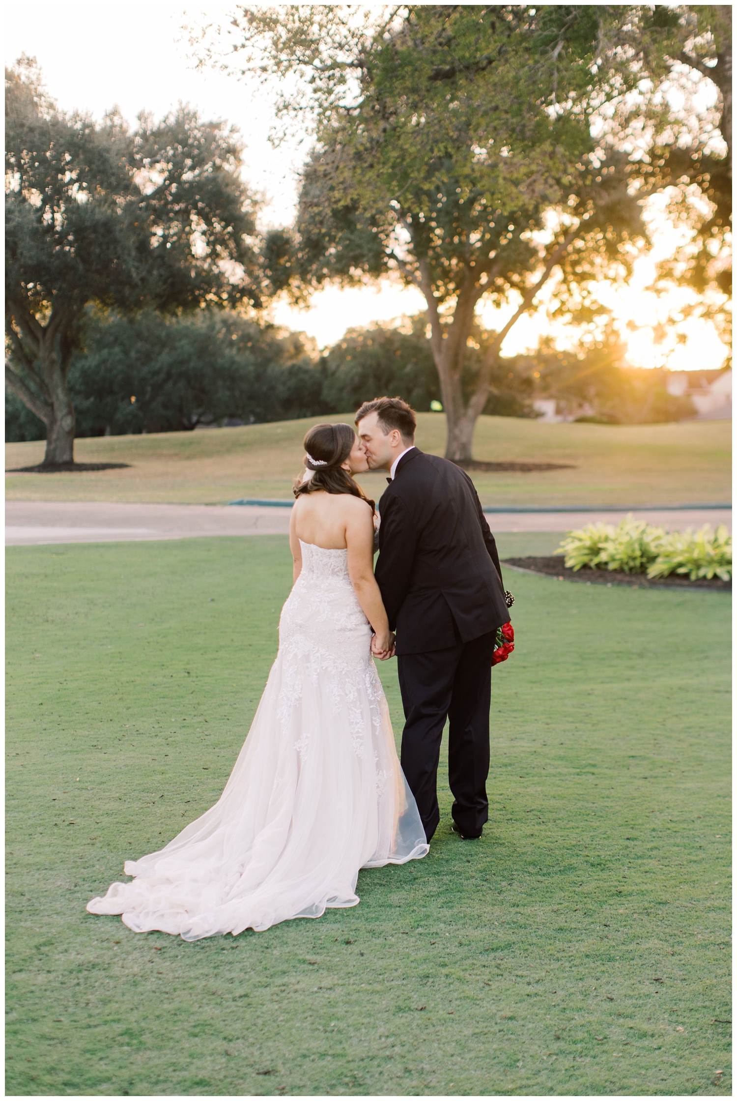 bride and groom kissing on grounds outside Sugar Creek Country Club wedding