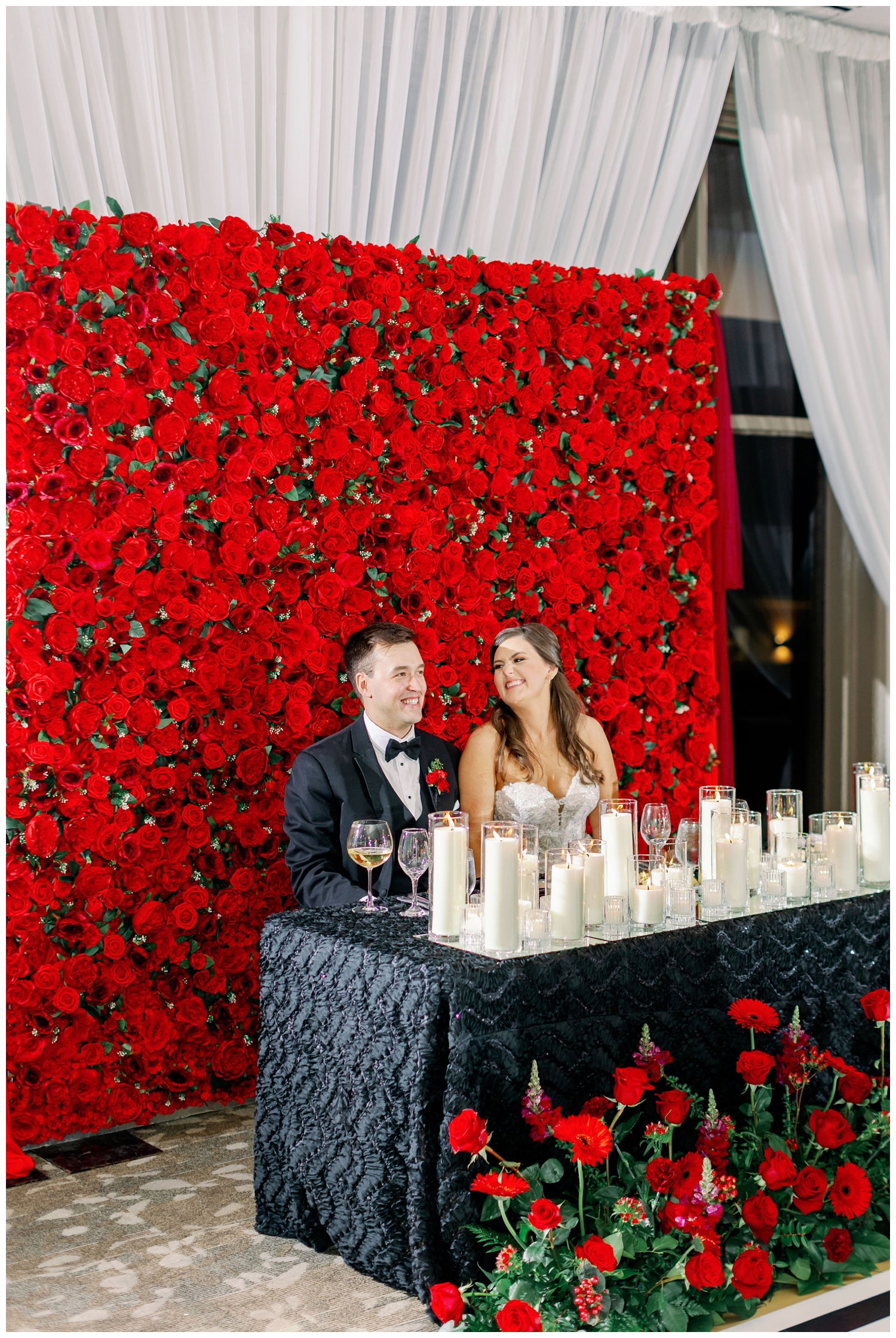 bride and groom sweetheart table red roses inside Sugar Creek Country Club