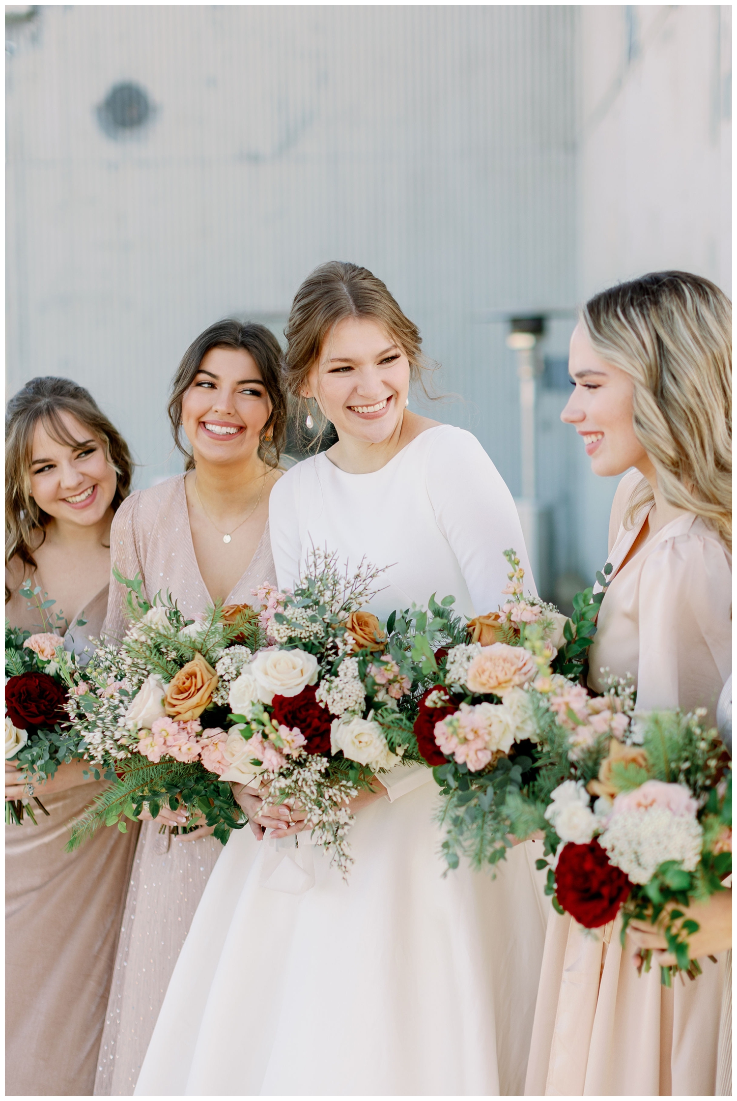 bride smiling and laughing with bridesmaids for College Station wedding photography portraits