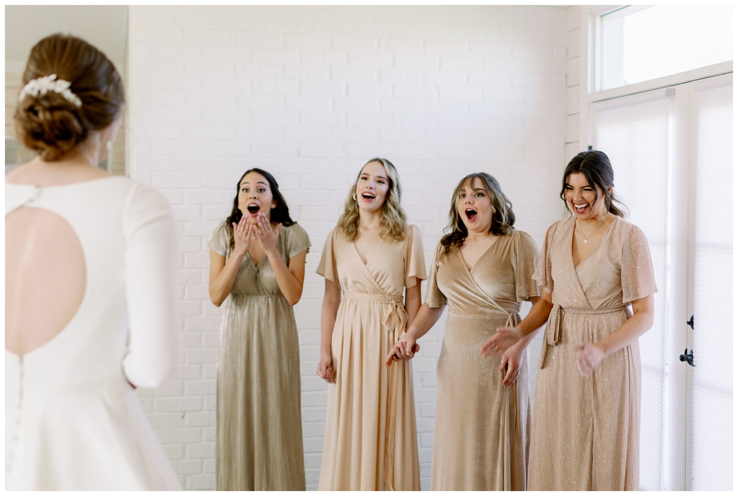bridesmaid reveal with bridesmaids smiling at bride inside bridal suite at Gin at Hidalgo Falls