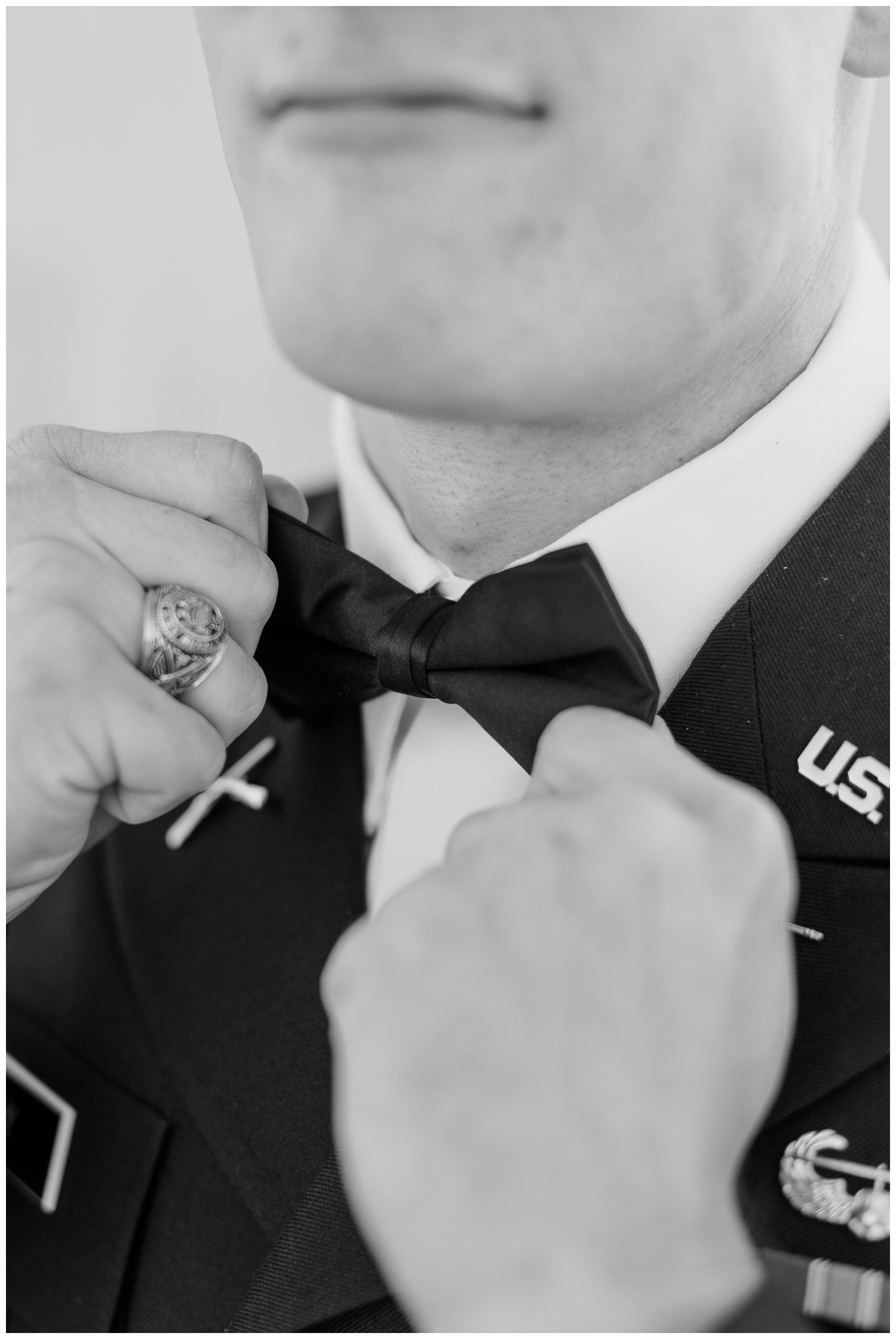 black and white image of groom touching bow tie College Station wedding photography