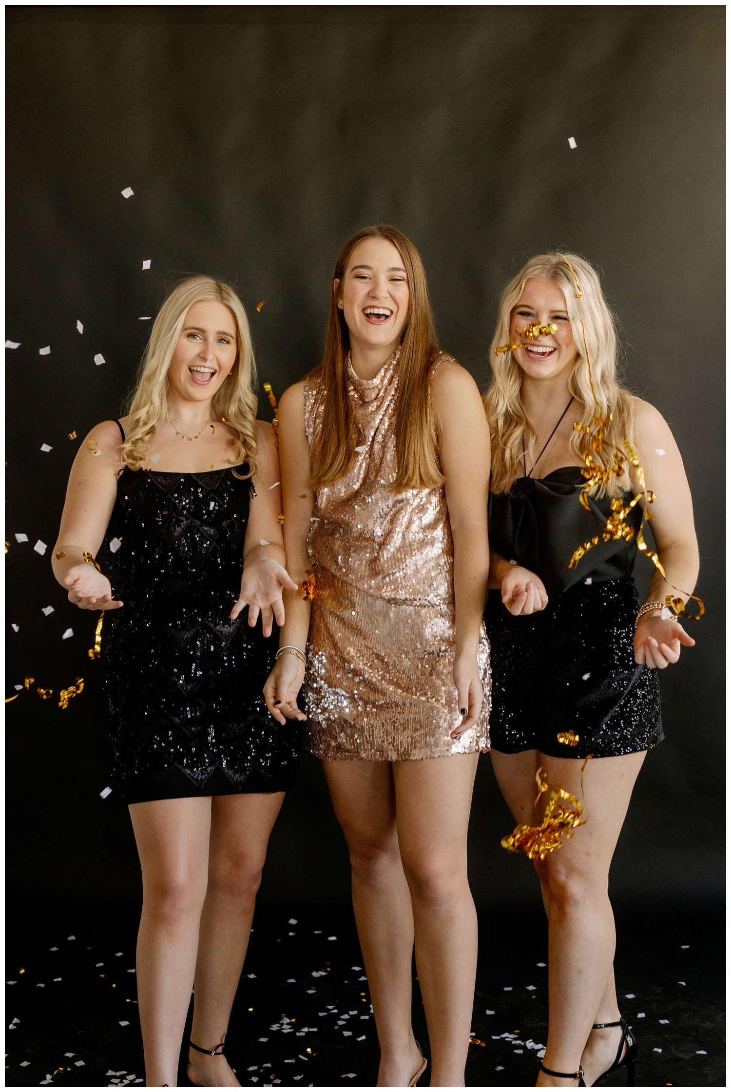 confetti shot with three high school senior girls in New Years dresses