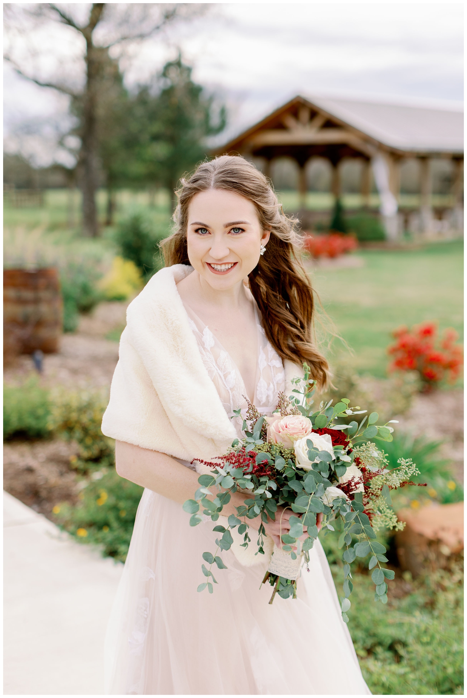 winter Union Ranch Wedding with bride smiling holding white and burgundy bouquet