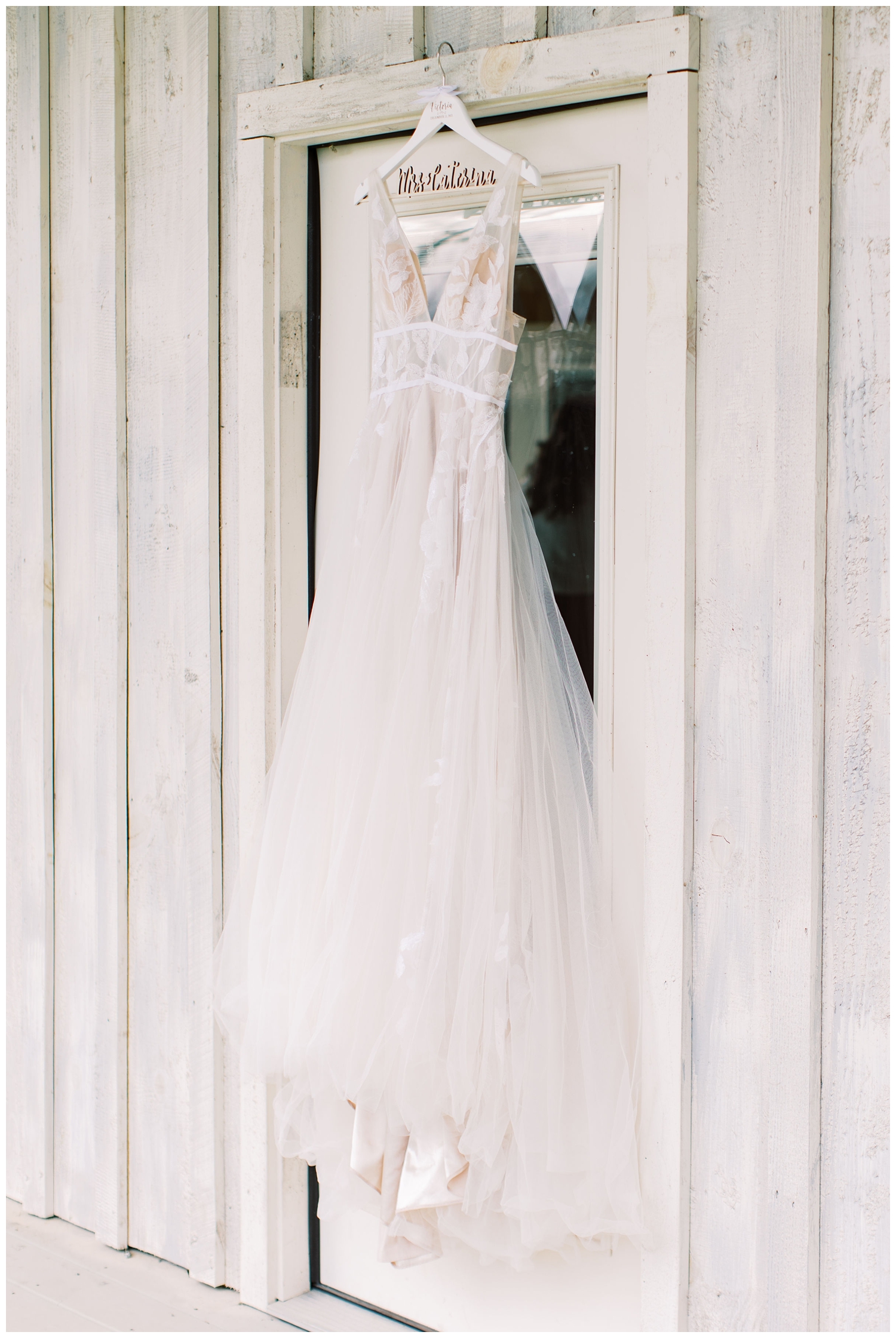 white wedding gown hanging outside bridal suite for Union Ranch wedding