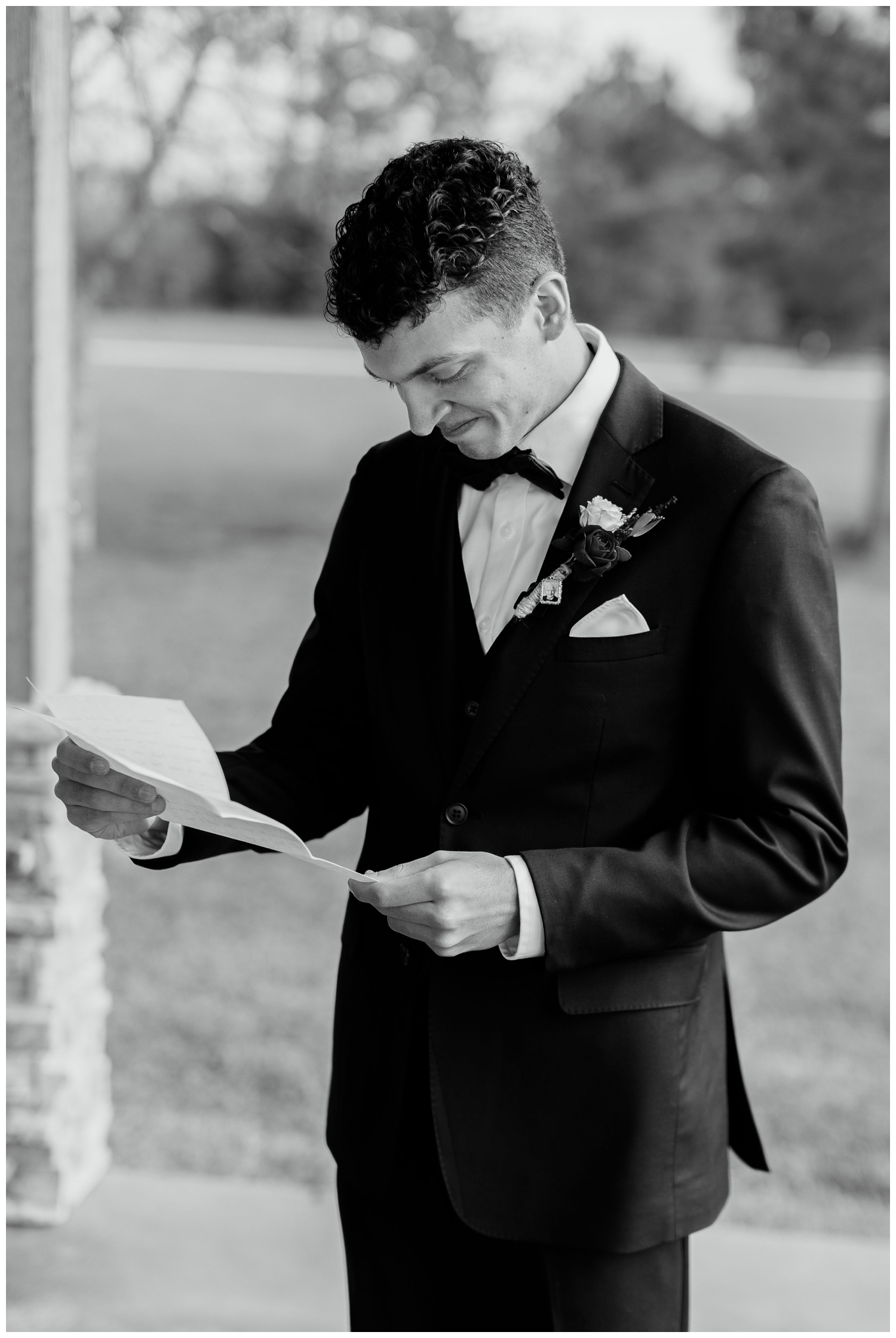 black and white image of groom reading love letter for Union Ranch wedding