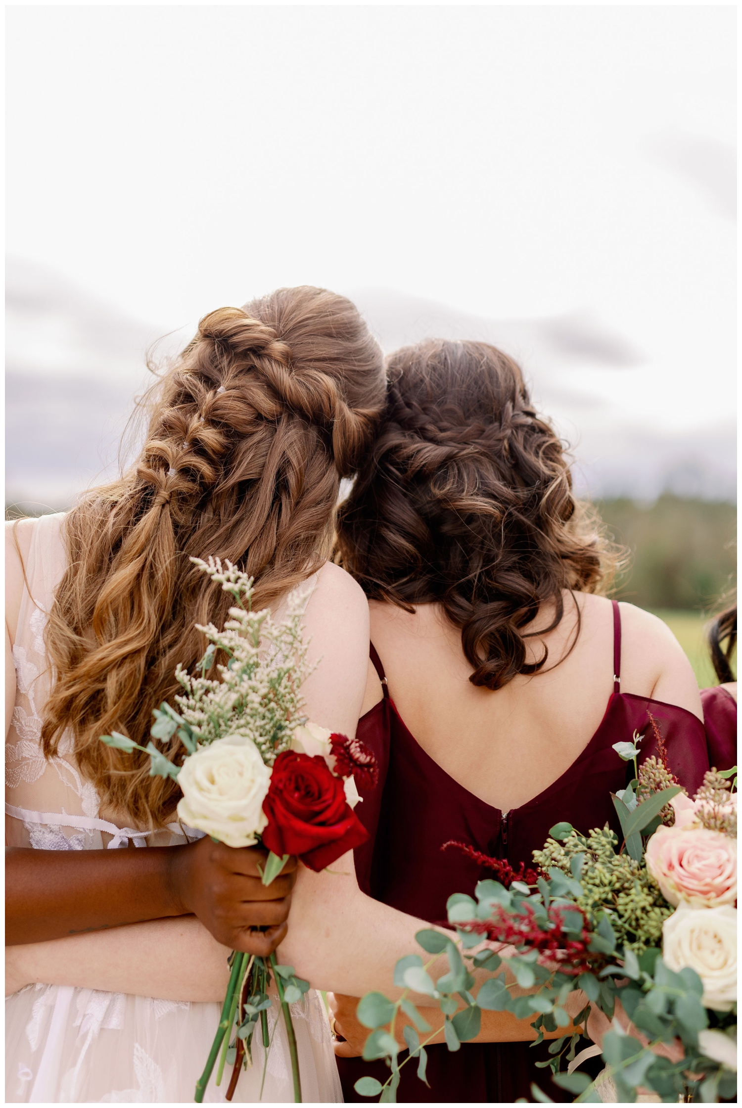 bride and bridesmaid hugging image from behind