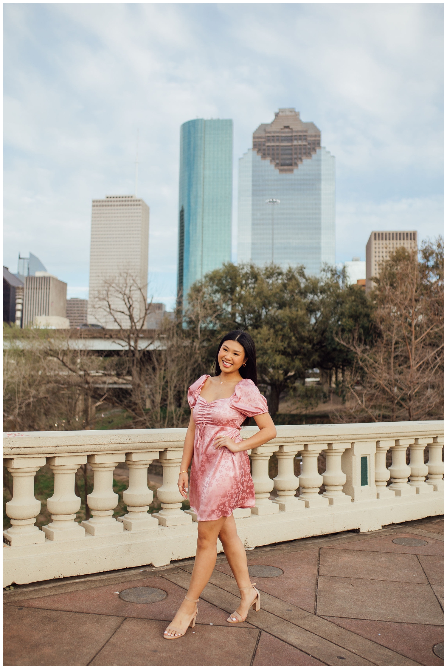 Houston senior girl standing on Sabine Street Bridge in front of Houston skyline