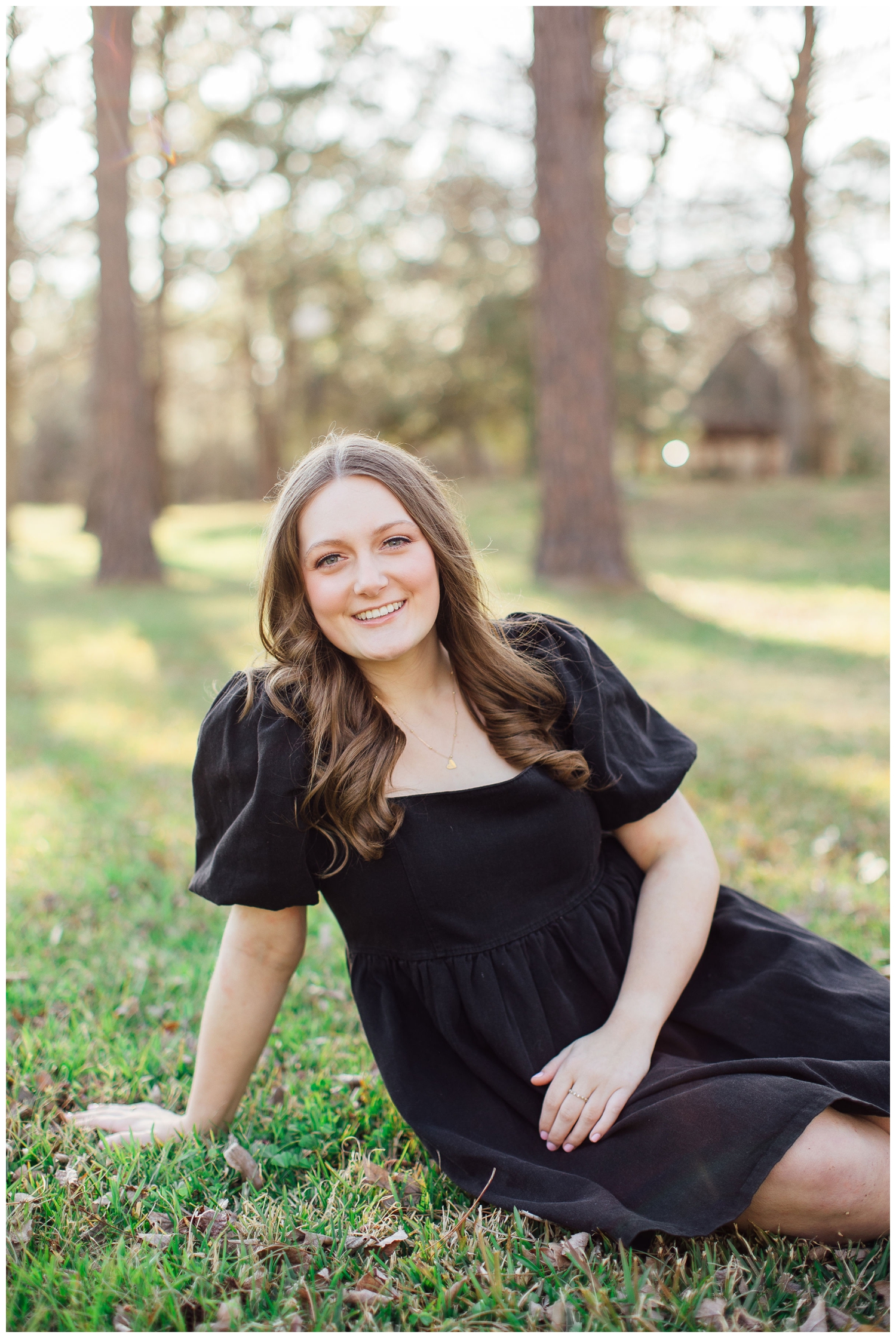 girl in black dress sitting in a field Cypress Texas at Cy-Hope