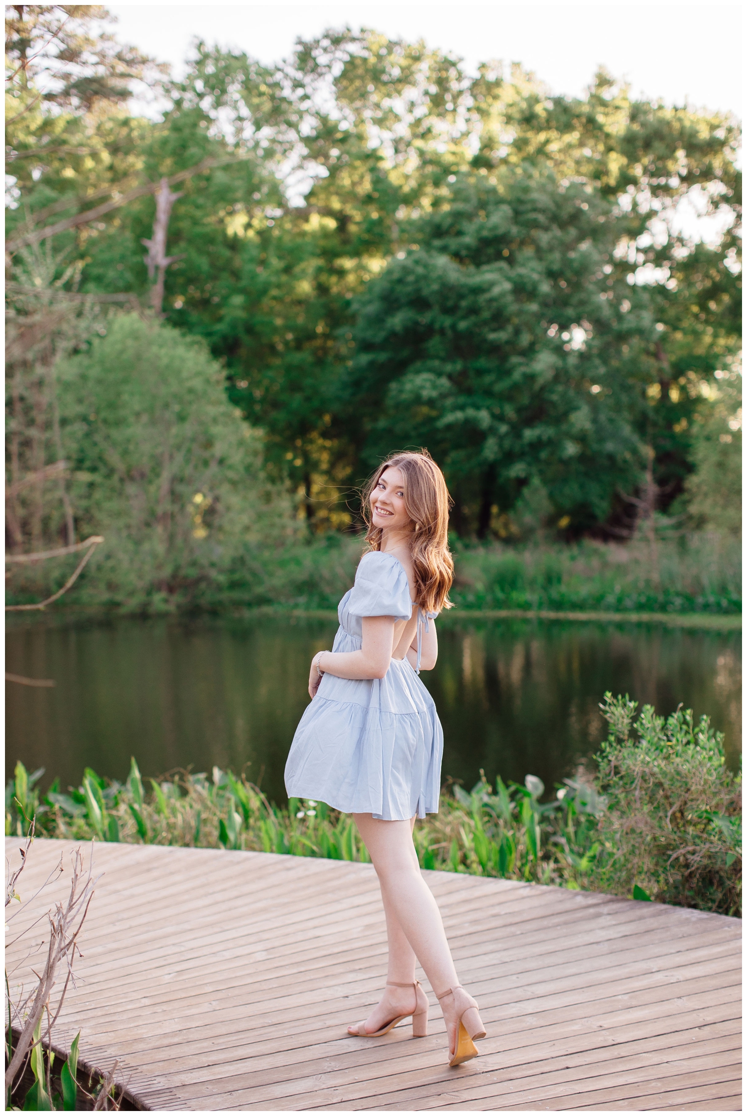 Houston senior portraits at pond inside Houston Arboretum girl in blue dress