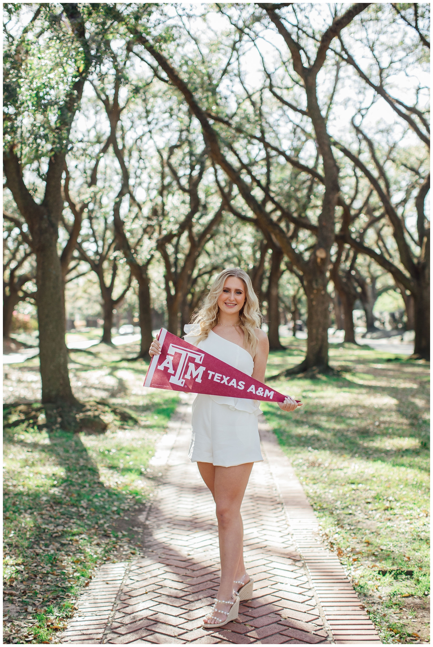 girl in white dress with Aggie flag for senior pictures Houston