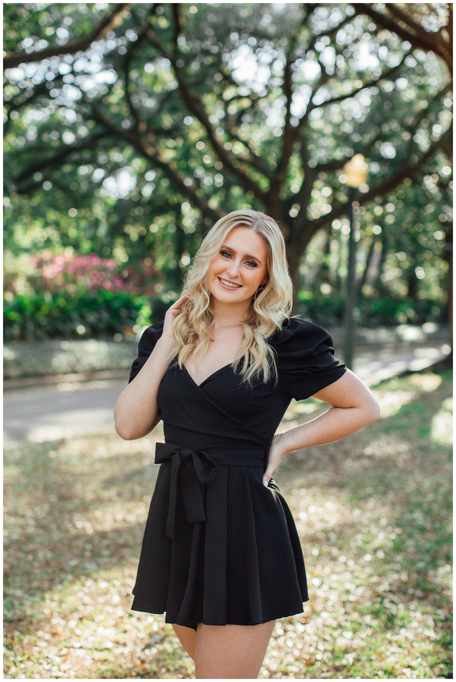 girl in black dress with hand in hair for Houston senior pictures at North South Blvd.