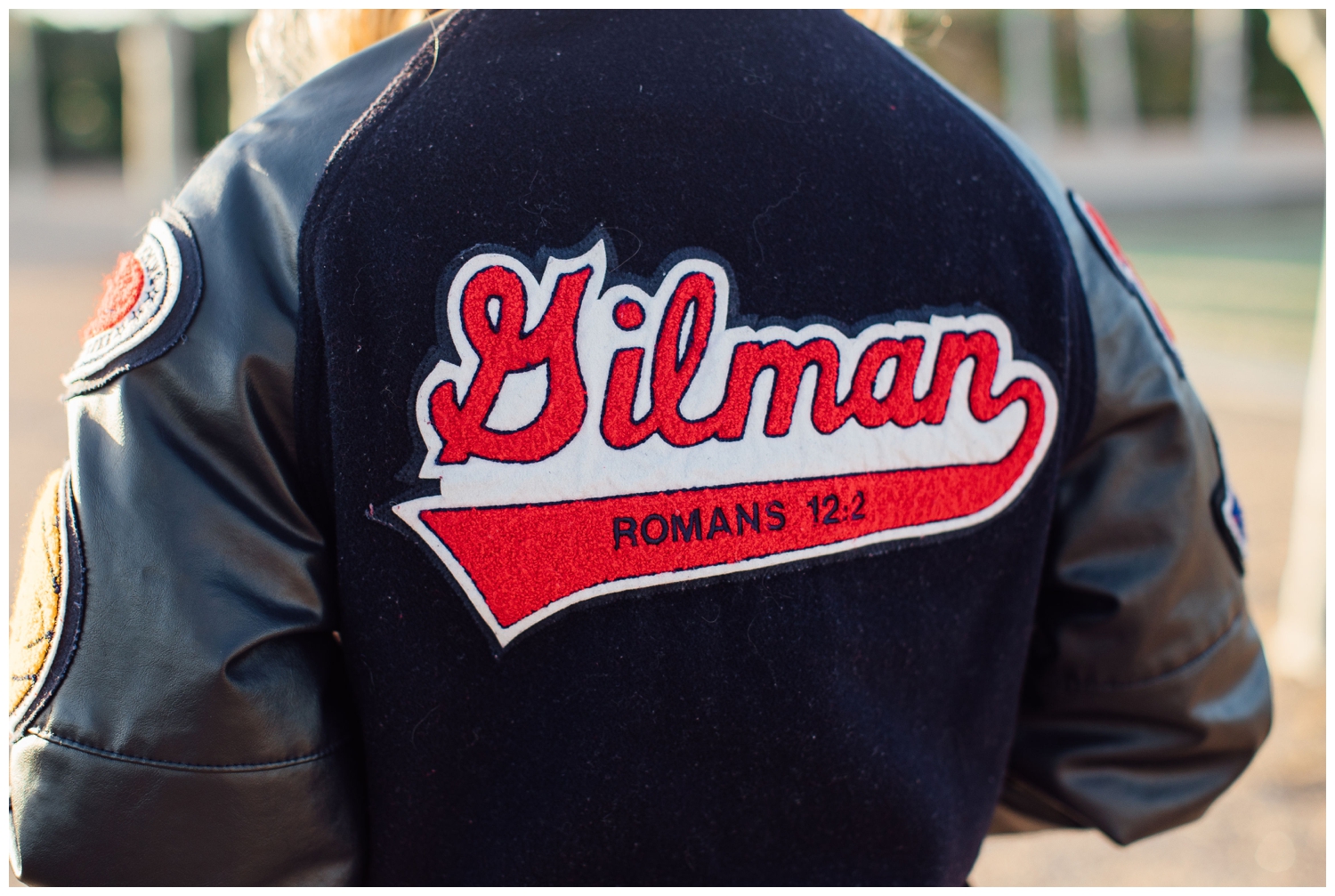photo of back of letter jacket that is navy red and white