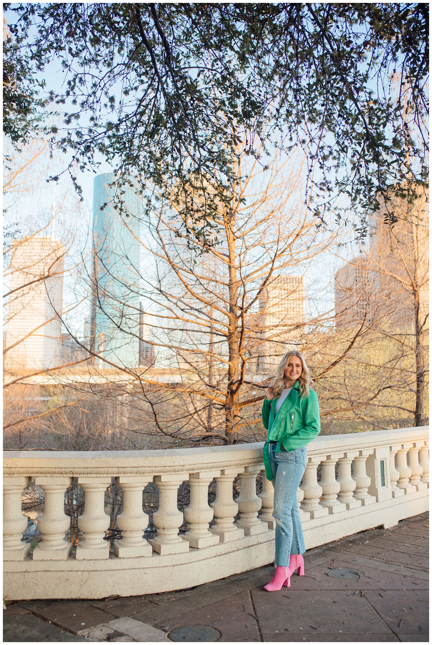 Sabine street bridge with high school senior girl wearing green jacket standing and smiling