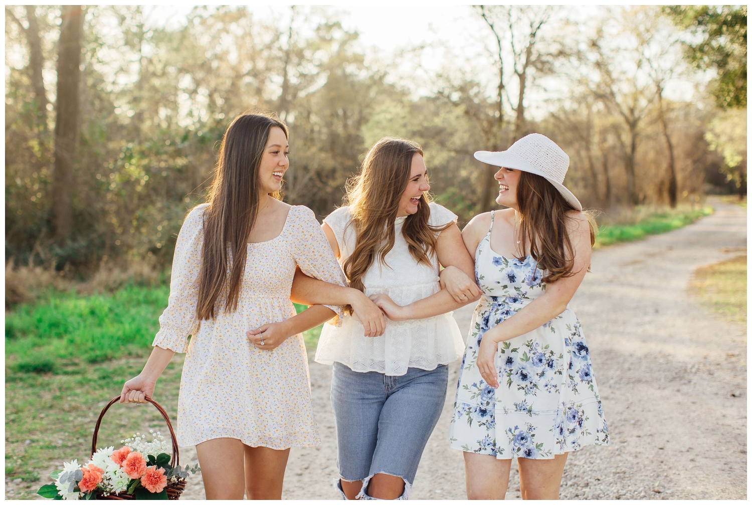 three high school seniors walking with arms locked together and laughing