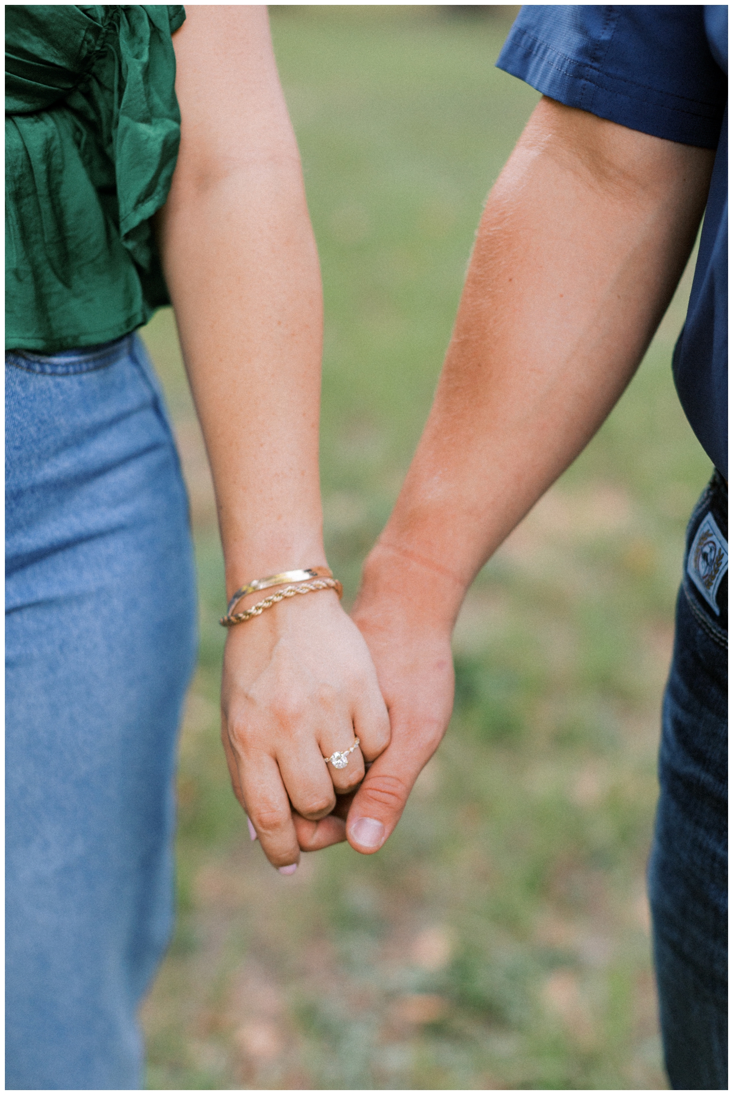 close up of couples hands inner twined during engagement photos Huntsville, Texas