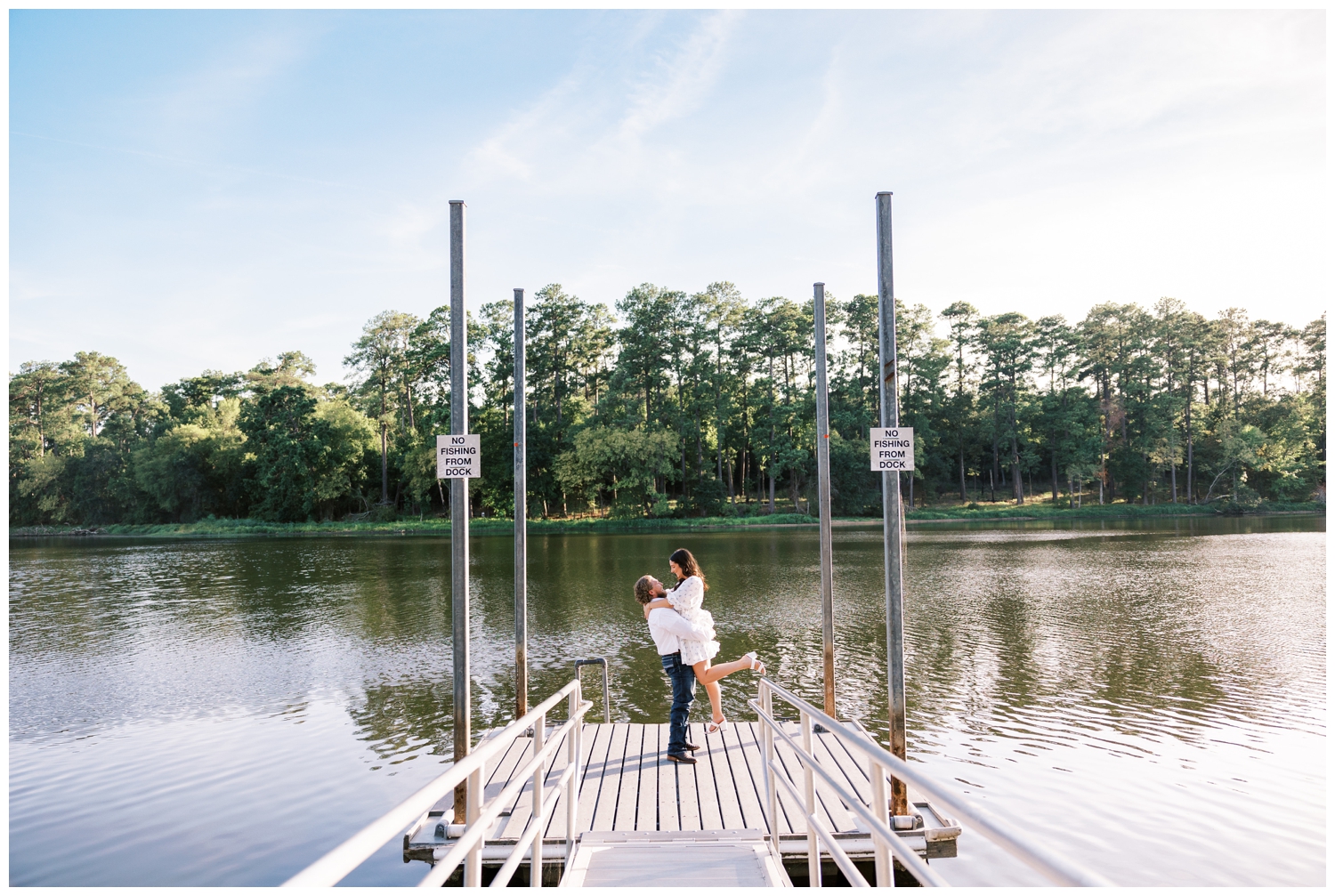couple doing a dip on a boat dock in front of the lake at engagement photos Huntsville, Texas