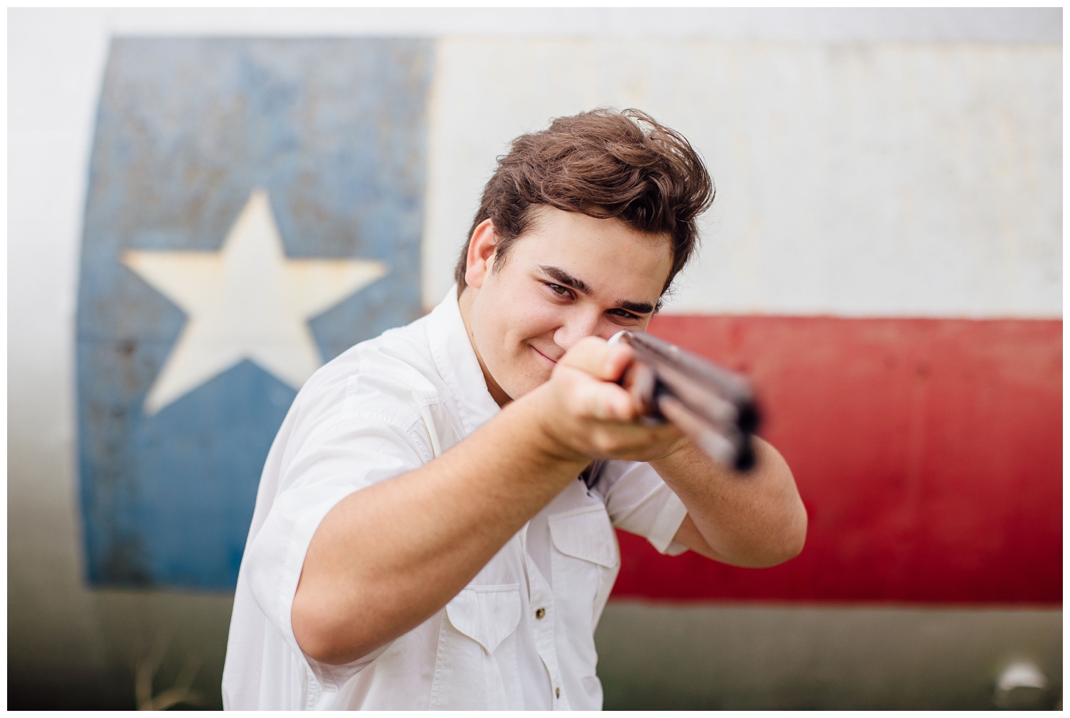 senior pictures for guys Houston, Texas on ranch with guy holding a hunting rifle