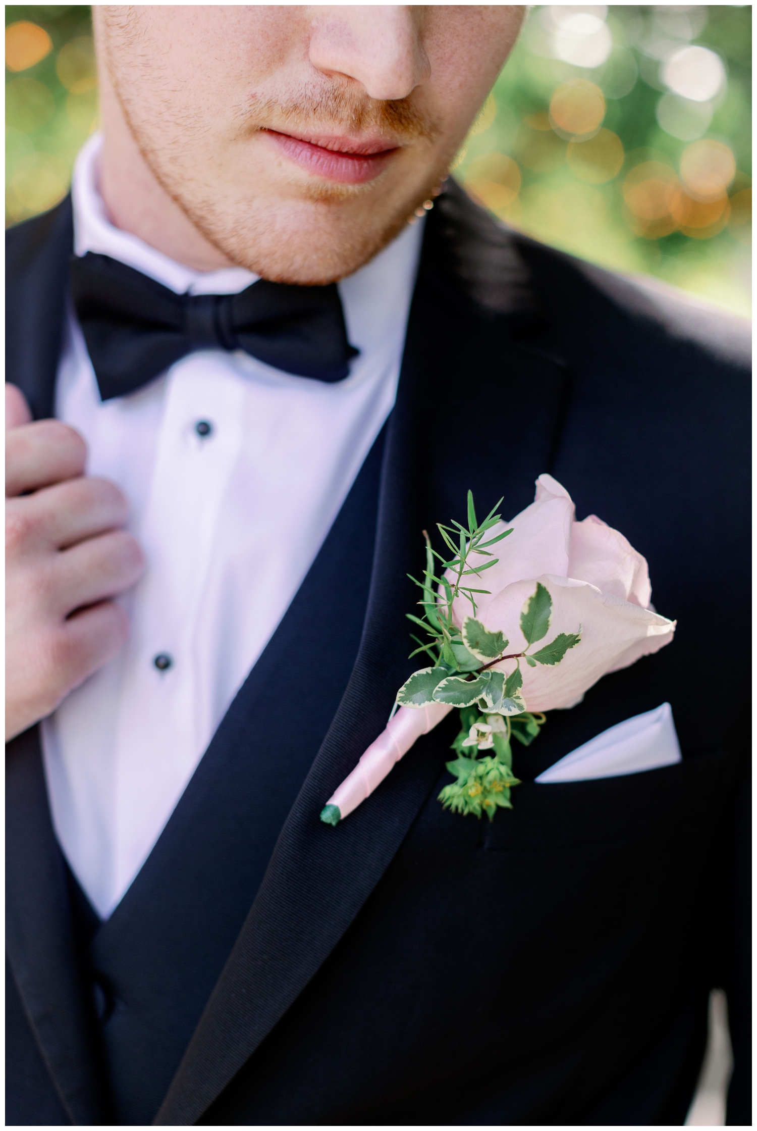 closeup image of groom holding jacket