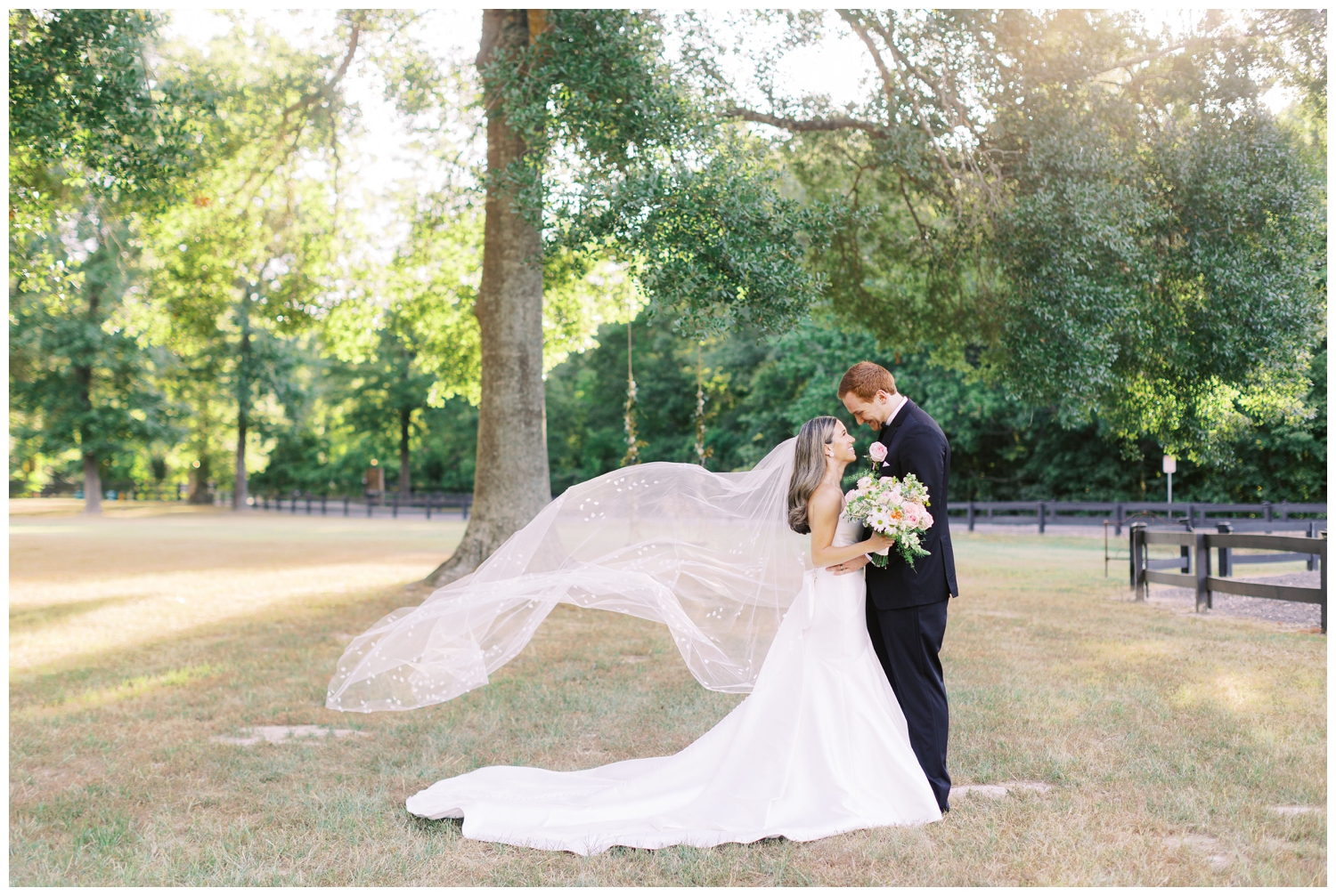 bride and groom portrait outdoors with veil toss