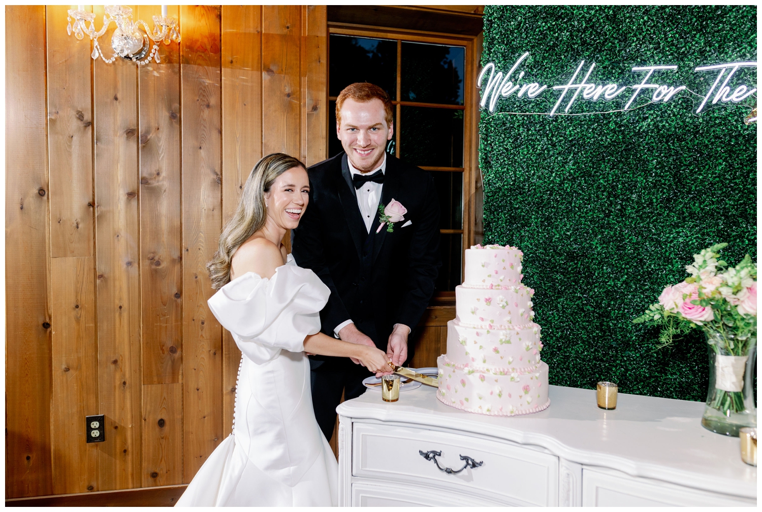 bride and groom cutting cake inside the Carriage House wedding reception space