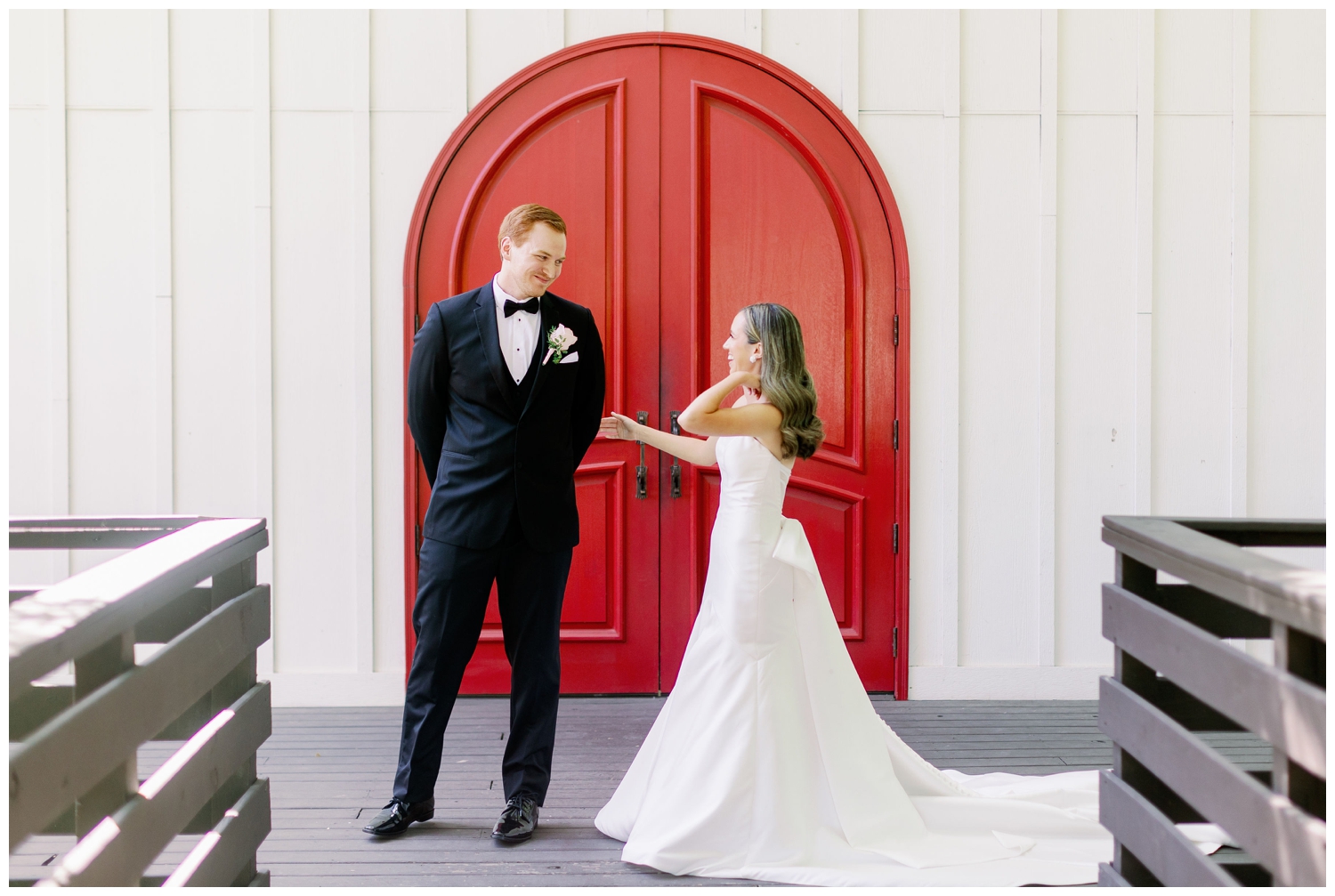 groom reacting to seeing his bride during first look The Carriage House Houston wedding venue red door