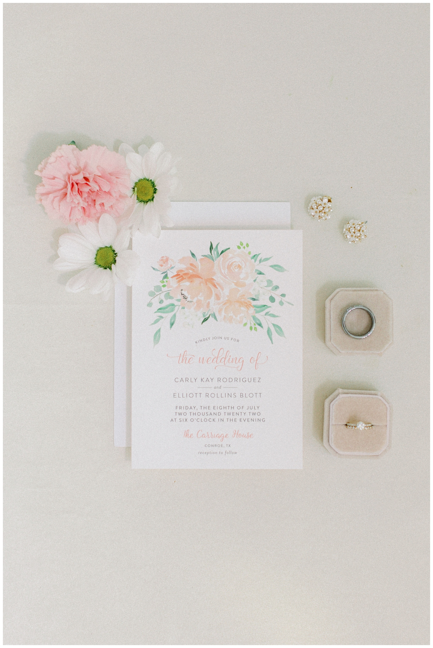 white and blush wedding invitation flatlay