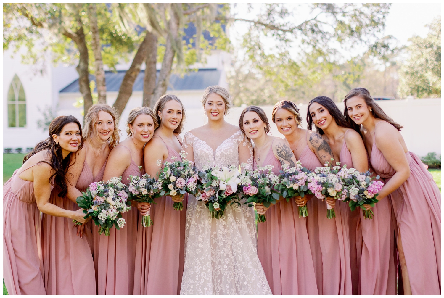 bride with bridesmaid portrait in blush dresses outside at The Springs Wallisville Wedding venue
