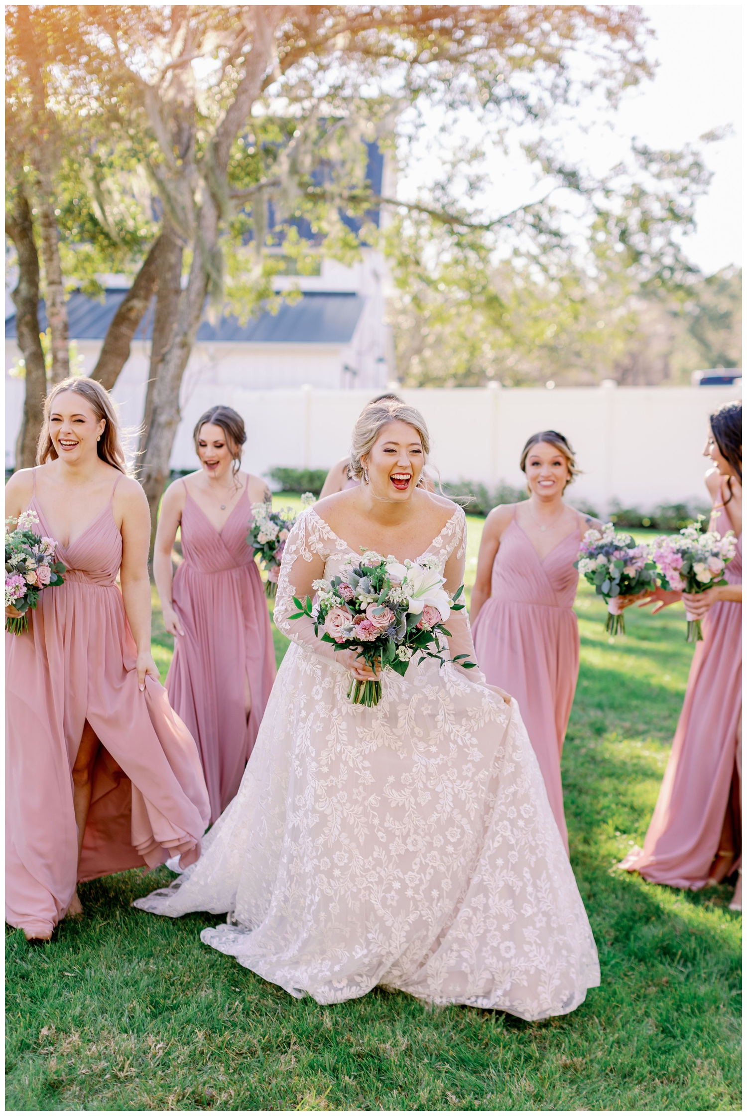 bride walking and laughing outside at The Springs Wallisville Wedding venue with bridesmaids walking by her side