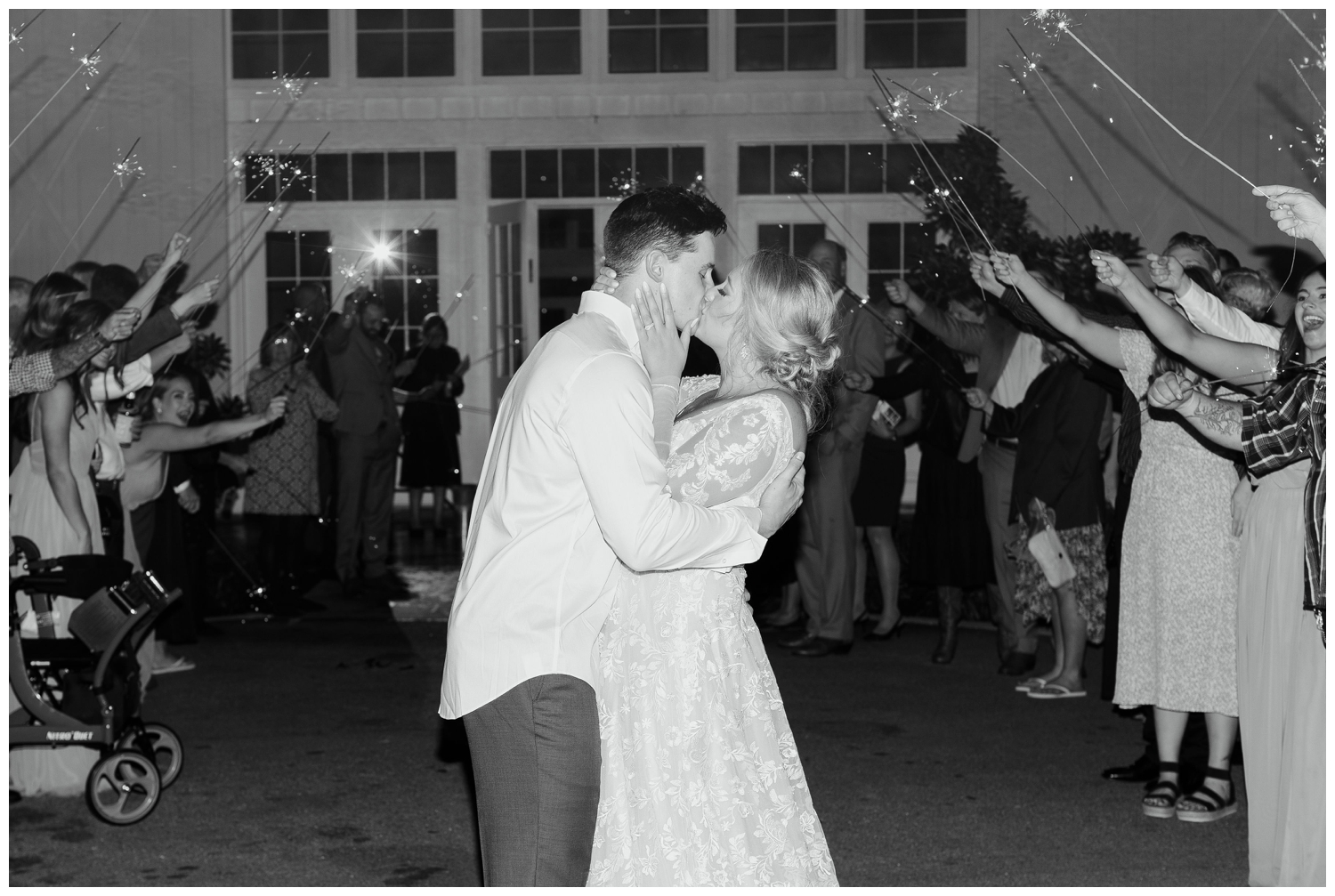 reception sparkler exit bride and groom kissing