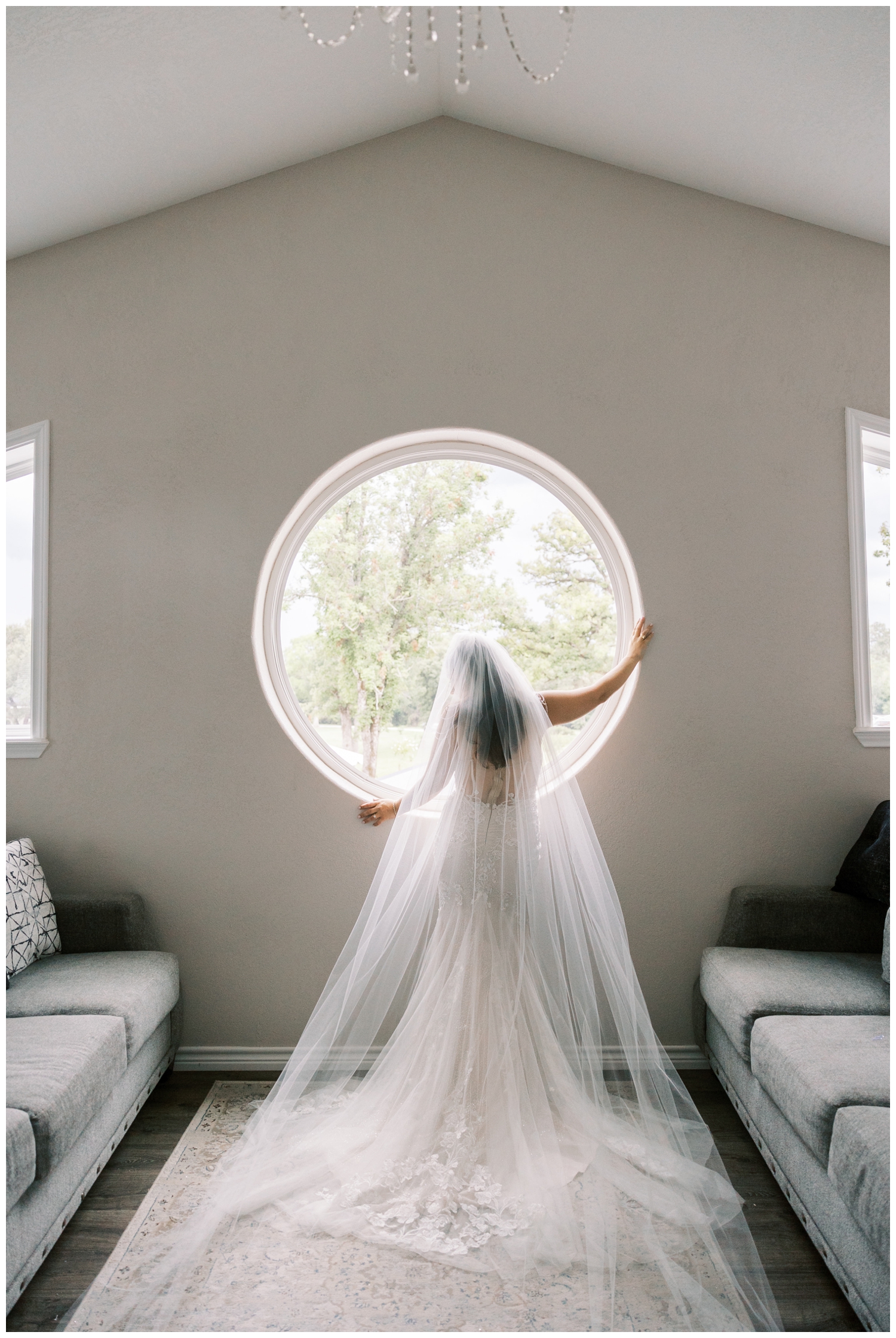 bride looking out circular window for bridal portait at Bluebird Haven Estates Wedding venue