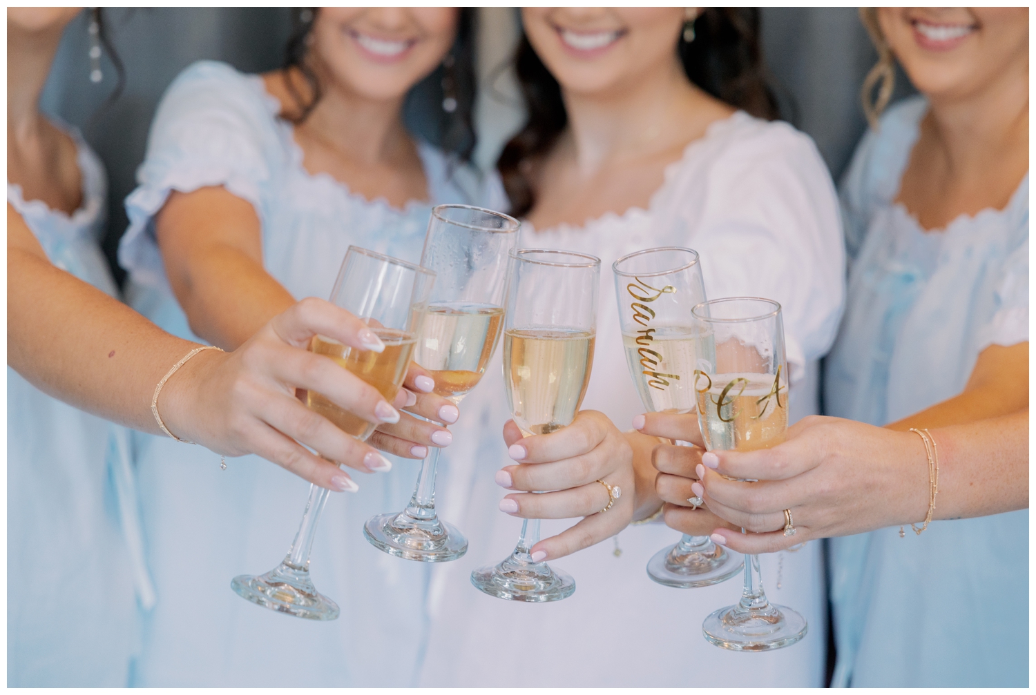 champagne toast with bride and bridesmaids in blue pajamas